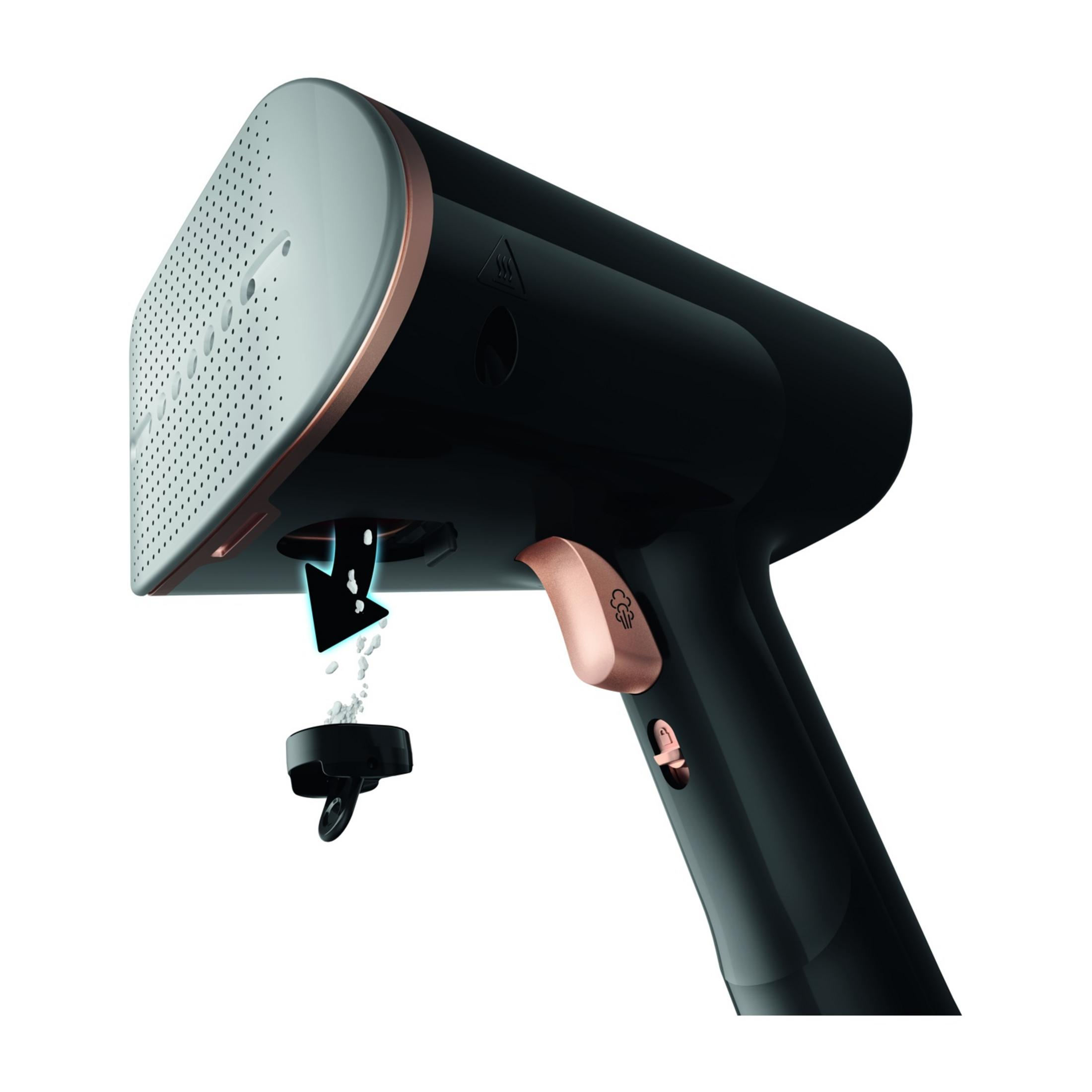 Czarna parownica z detalami w kolorze różowego złota, wydalająca kamień.