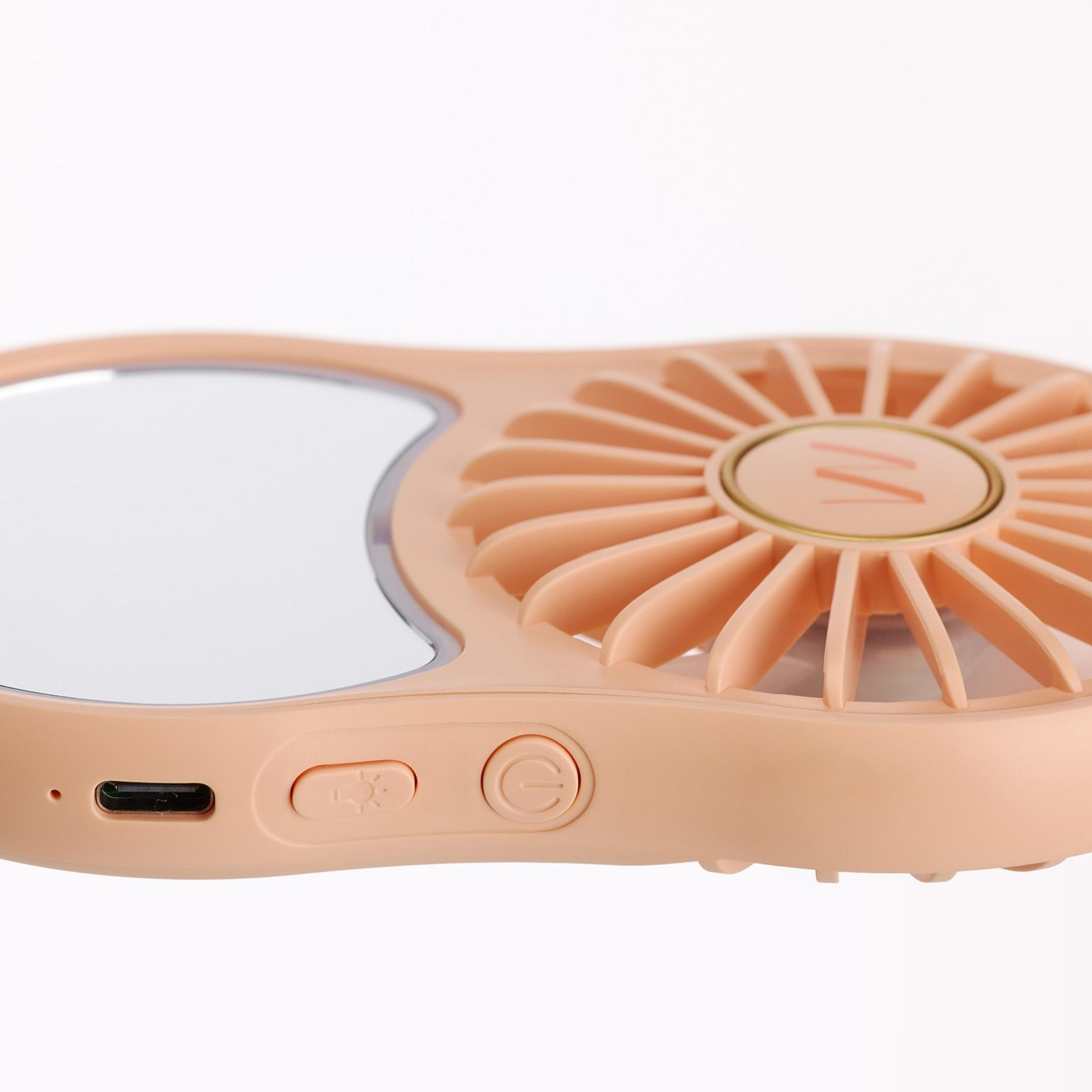 Un ventilatore portatile color pesca con specchio e porta USB-C.