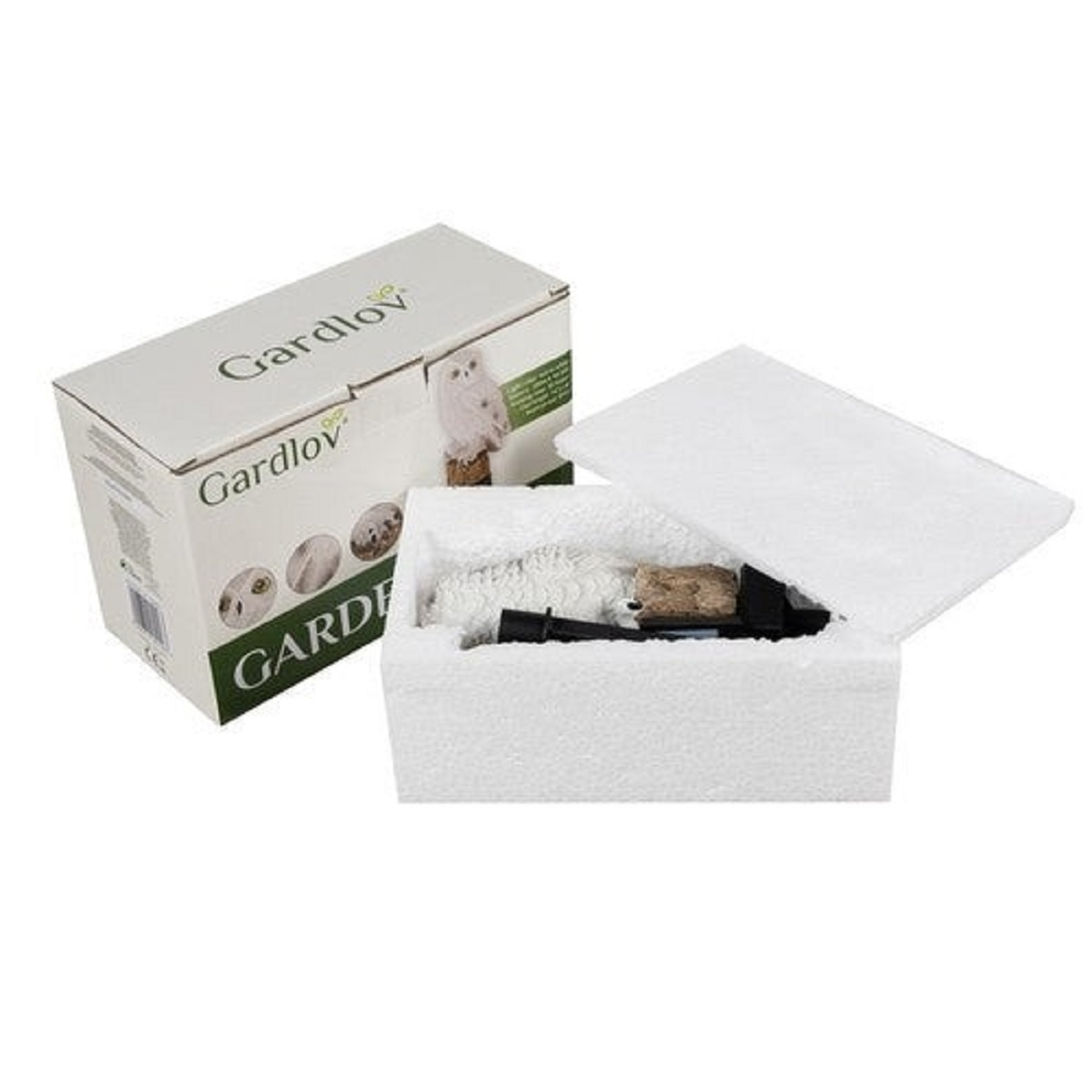 Una figura de búho blanco en embalaje de poliestireno junto a una caja Gardlov.