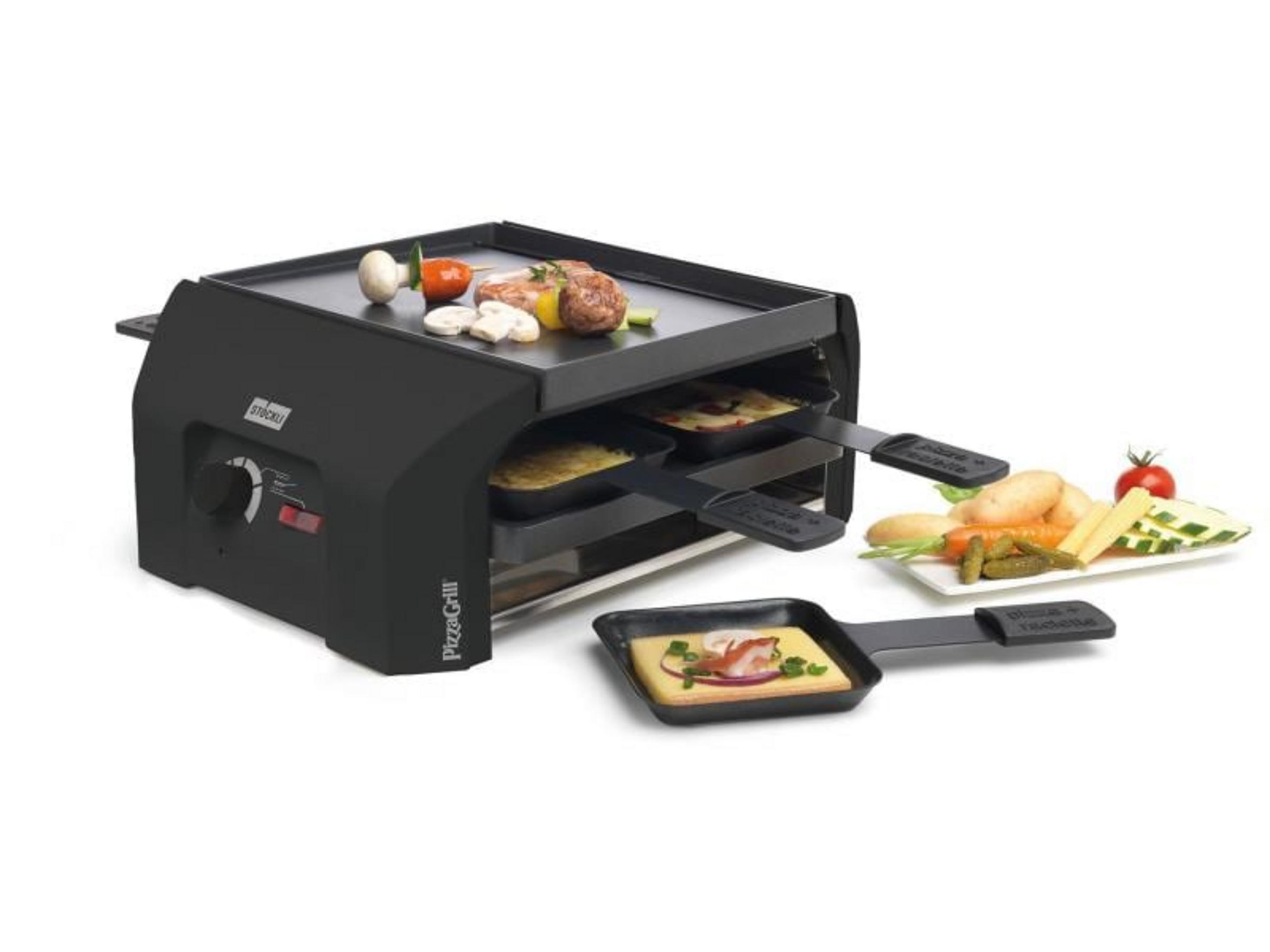 Ein schwarzer Raclette-Grill mit Fleisch, Pilzen und Gemüse auf der Platte.