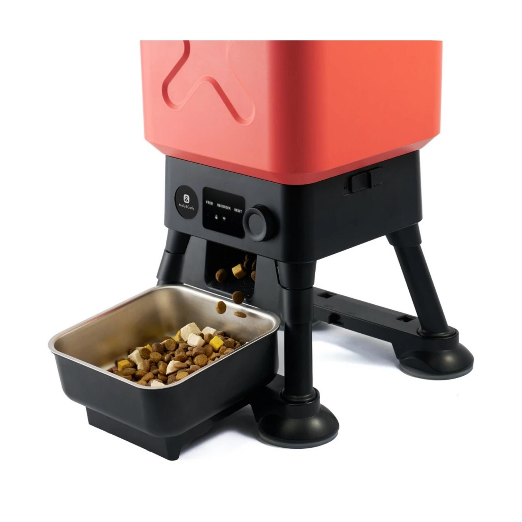 Un comedero automático rojo para mascotas con base negra y cuenco.