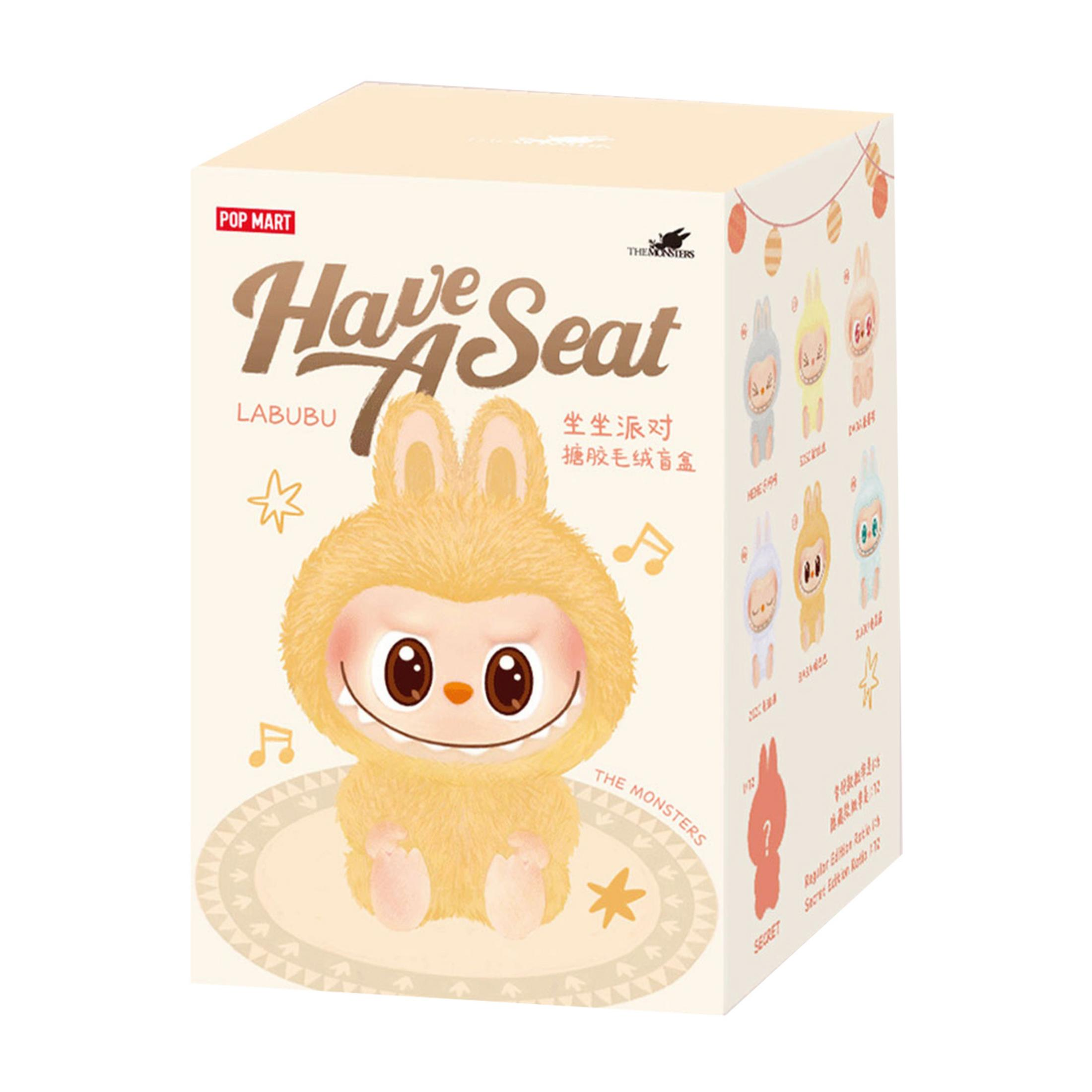 Eine gelbe Plüschfigur mit großen Augen auf einer Pappschachtel von POP MART.