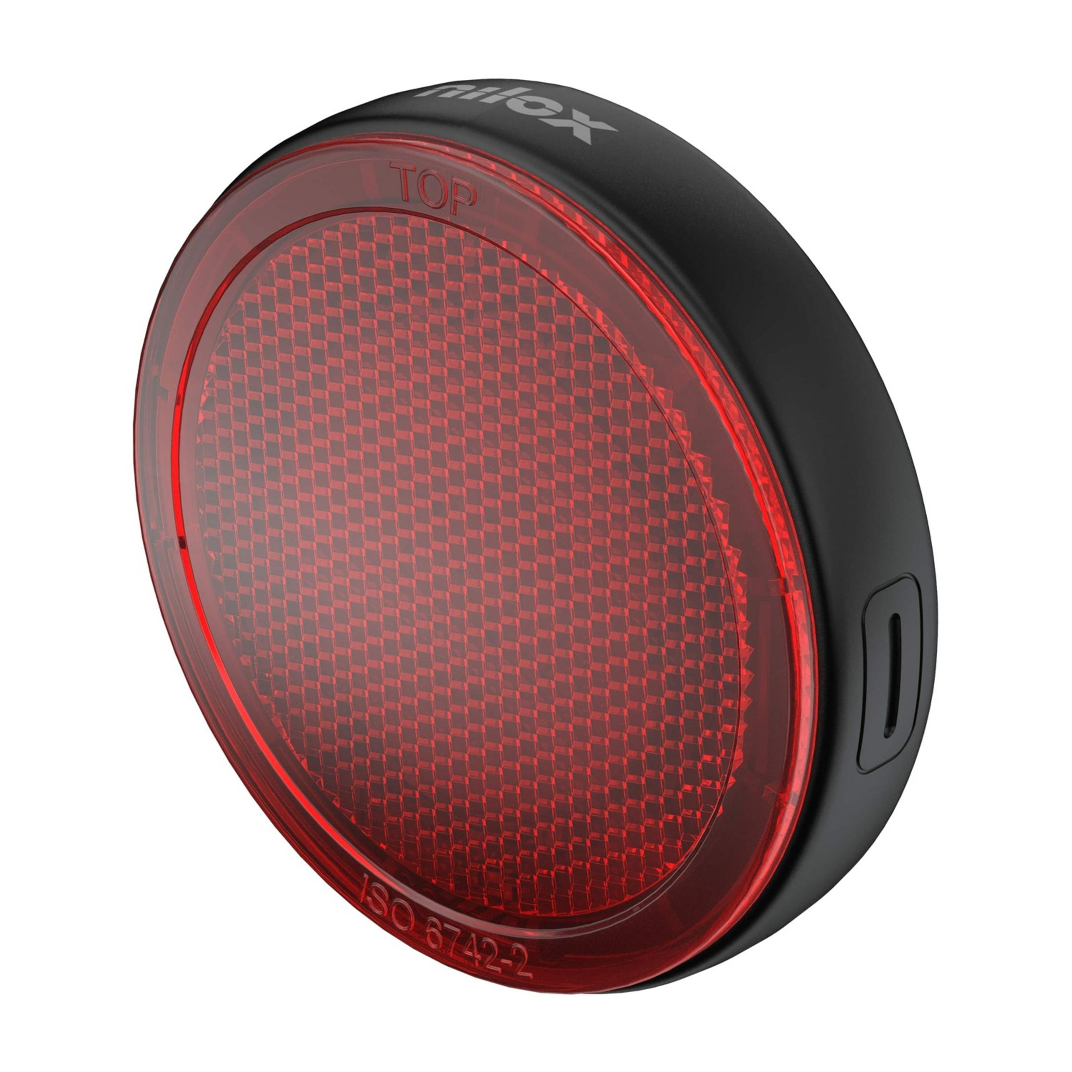 Czerwony odblask rowerowy z czarną obudową i oznaczeniem "TOP".