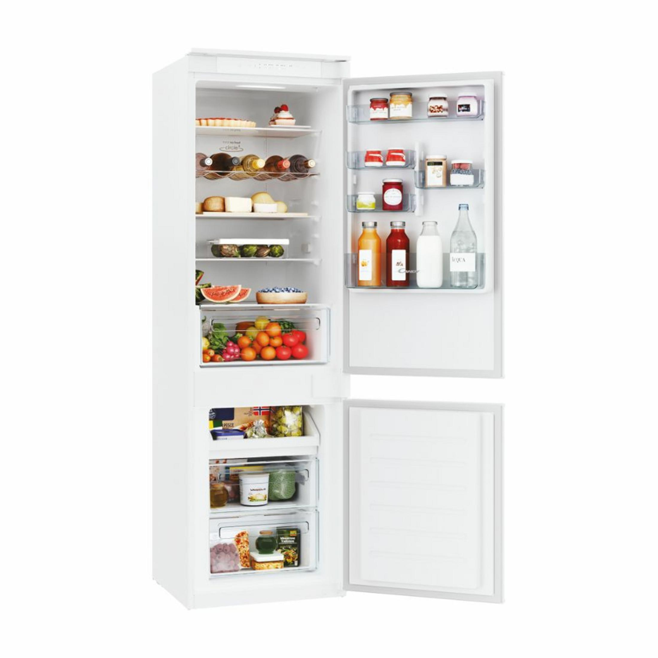 Un frigorifero bianco aperto pieno di cibo.