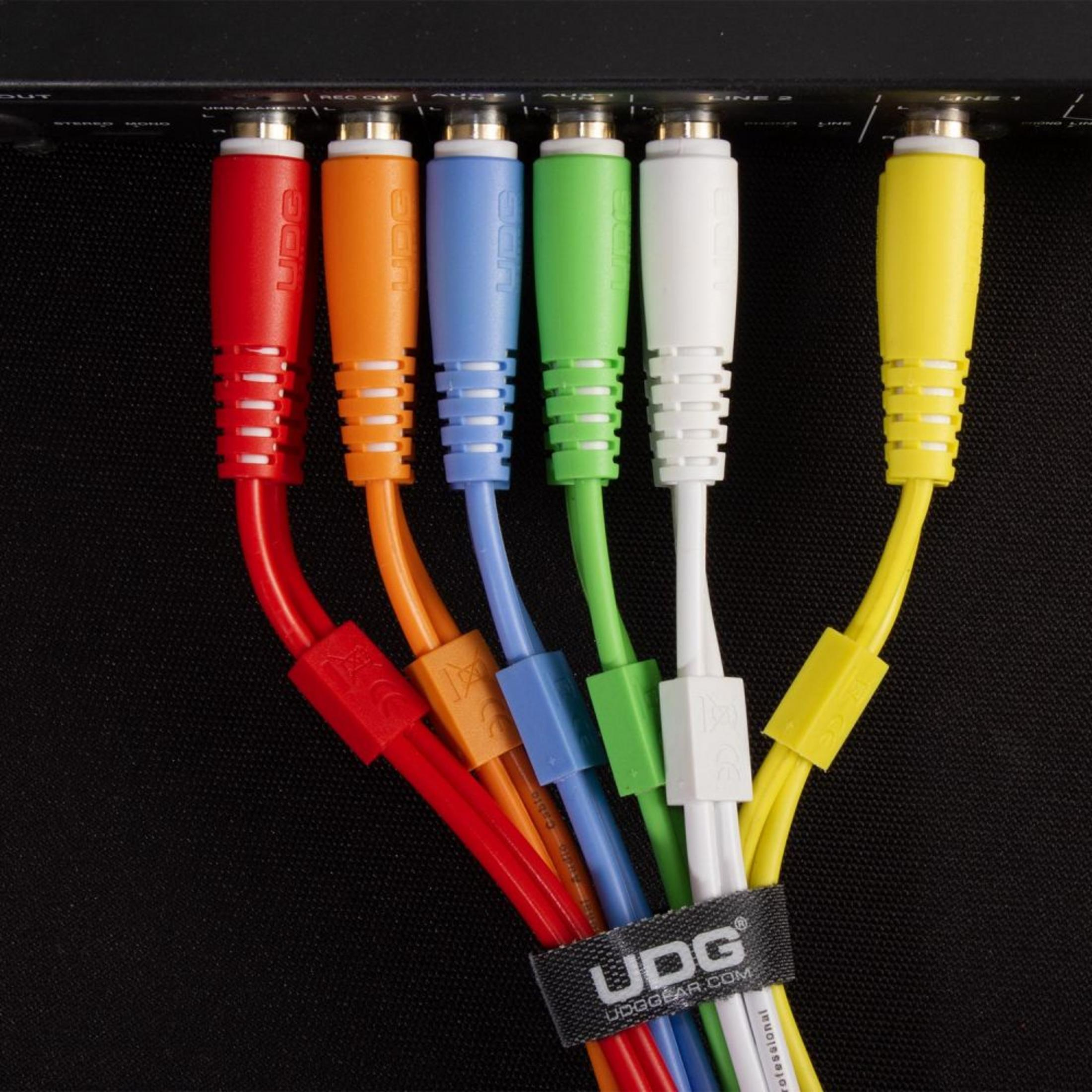 Bunte Audiokabel in ein schwarzes Gerät gesteckt. Rote, orange, blaue, grüne, weiße, gelbe Kabel.