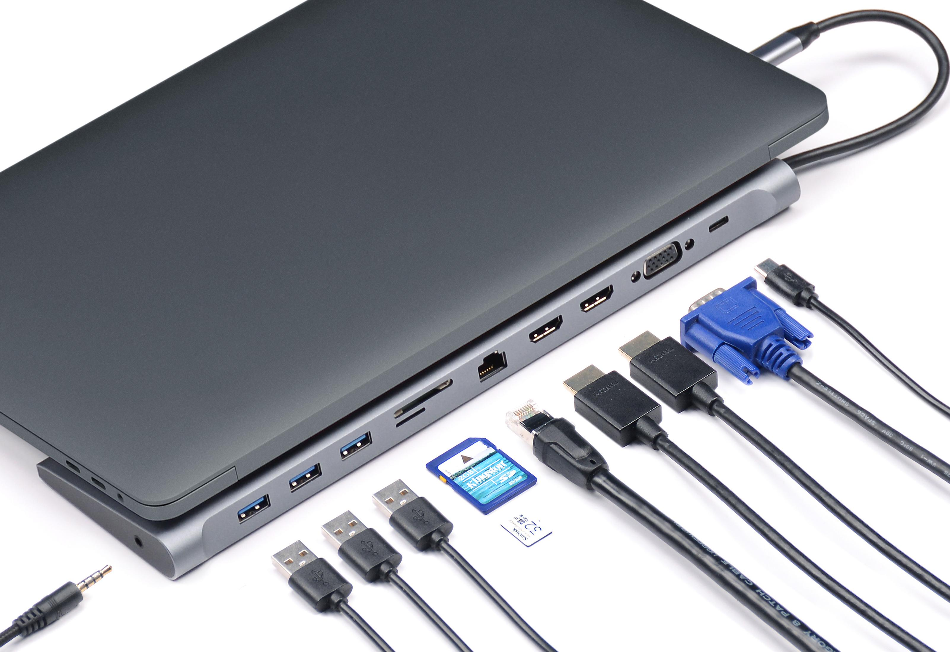 Ein graues Laptop-Docking-Gerät mit vielen Anschlüssen und Kabeln.