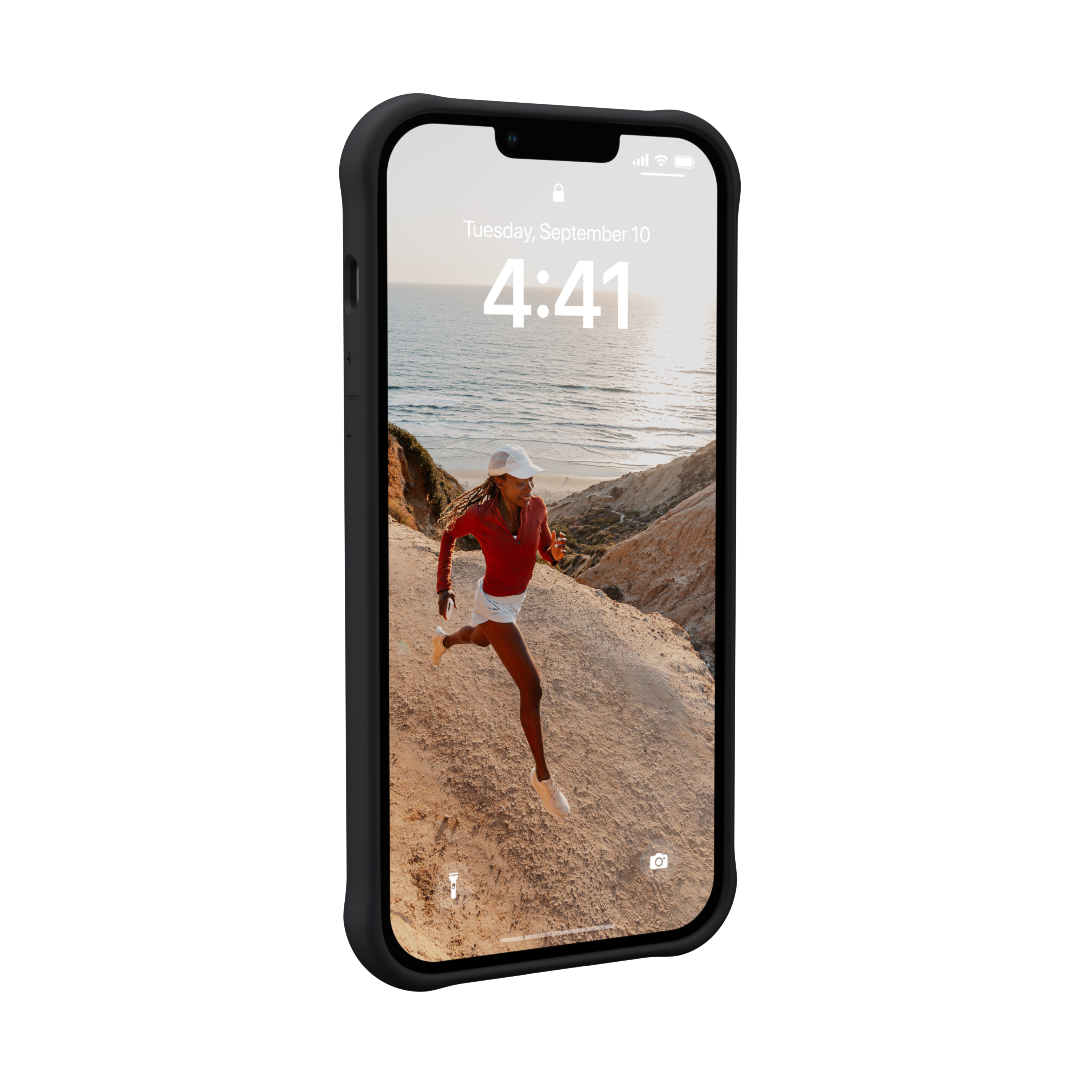 Ein Smartphone zeigt eine Frau beim Laufen am Meer im Sonnenuntergang.