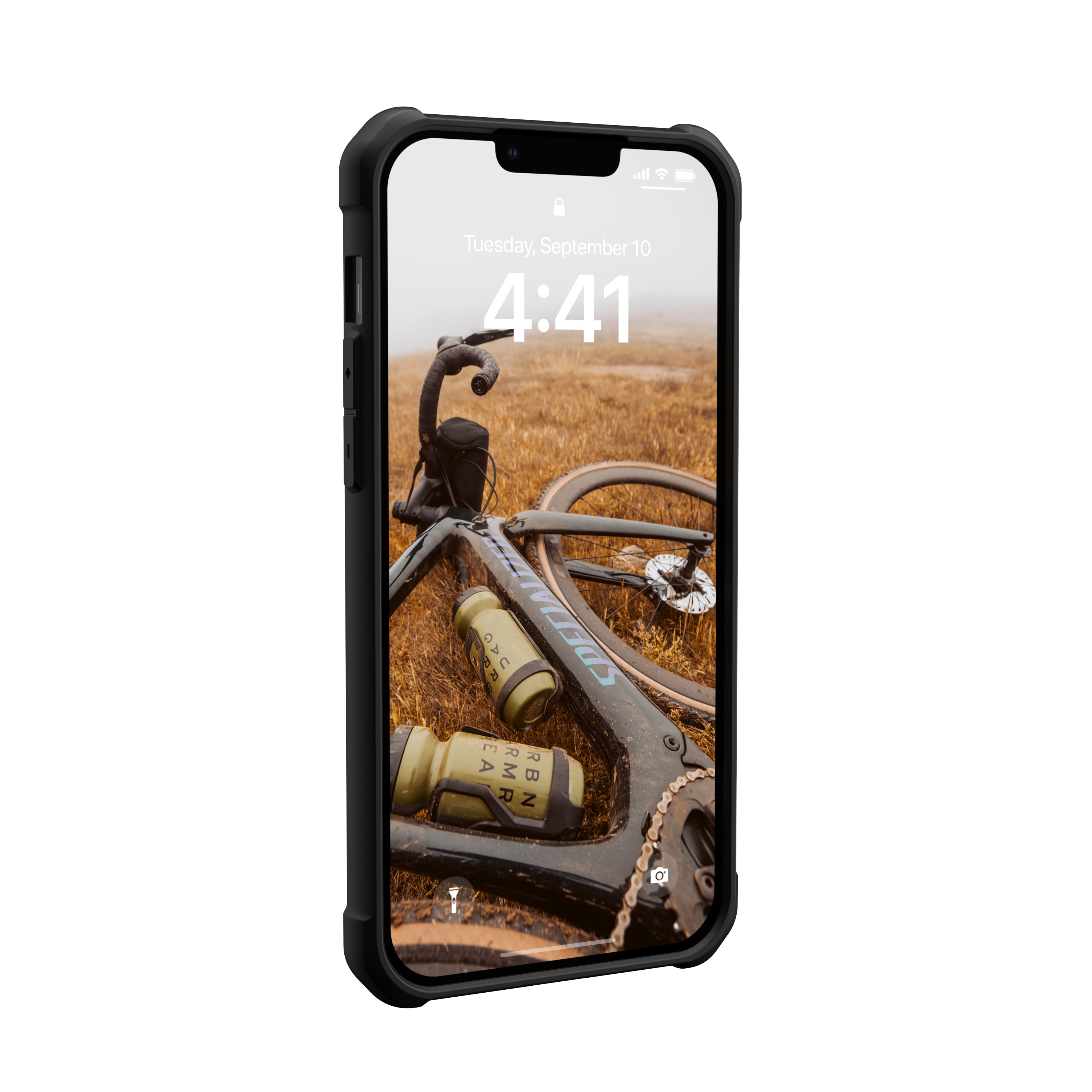 Ein Smartphone zeigt ein Fahrrad mit zwei Trinkflaschen auf trockenem Gras.