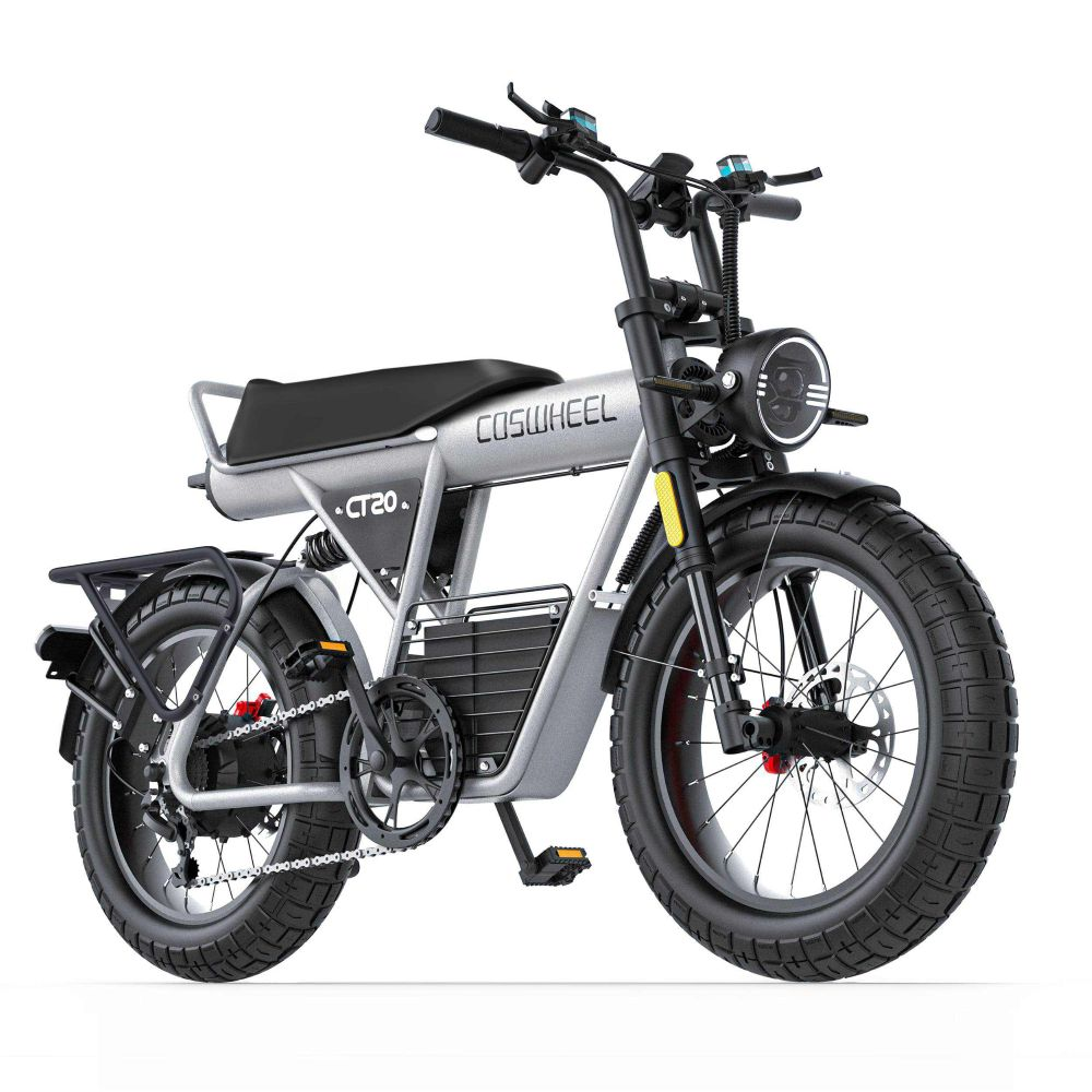 E-bike argento con pneumatici spessi, sella nera e faro rotondo.