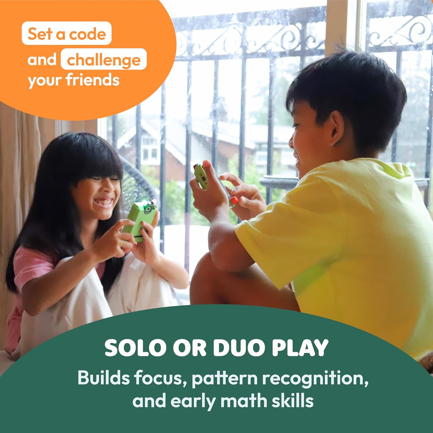 Two children play with green devices in front of a window. Focus on the devices.
