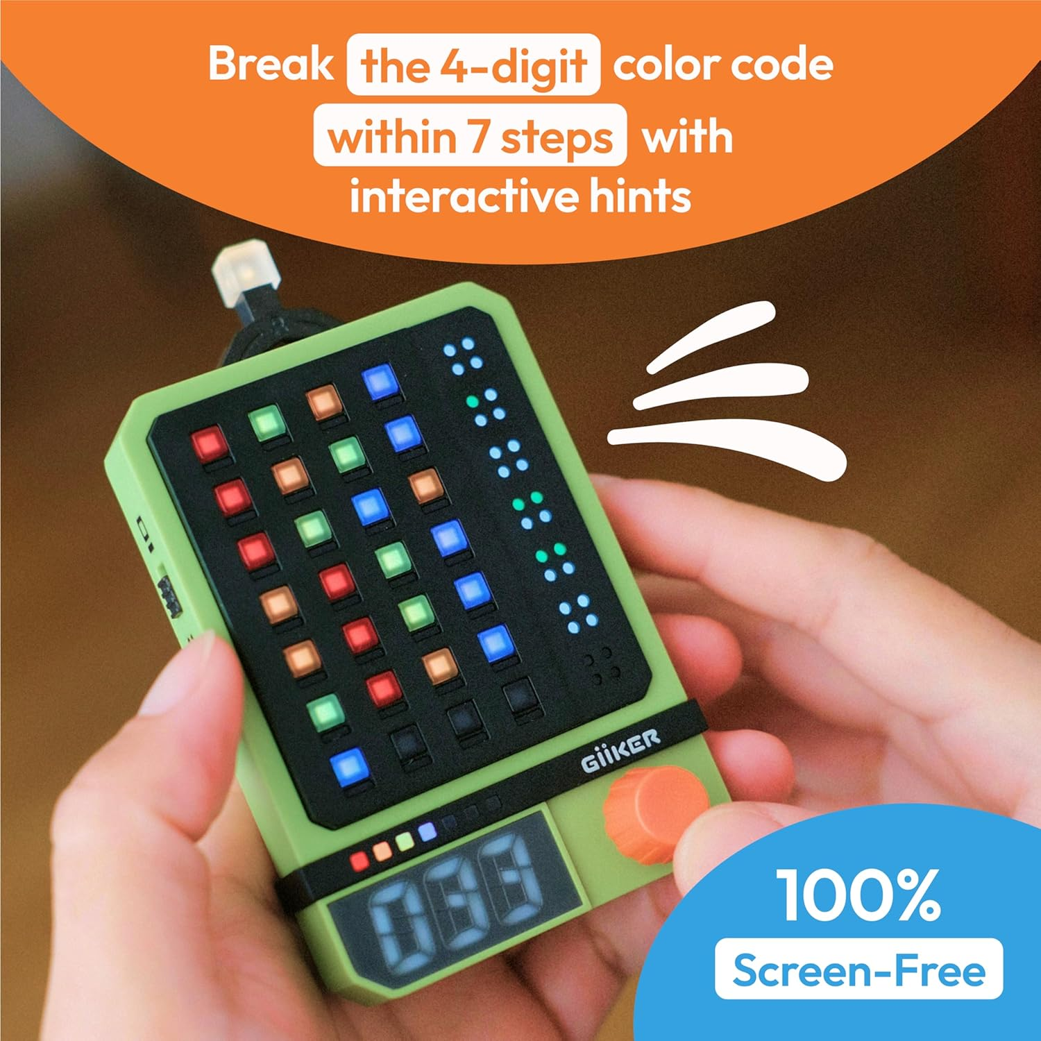 Green game device with colored lights and a dial. Held by 2 hands.
