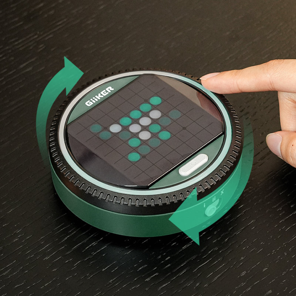 A green Giiker game device with a pixel display showing an arrow.