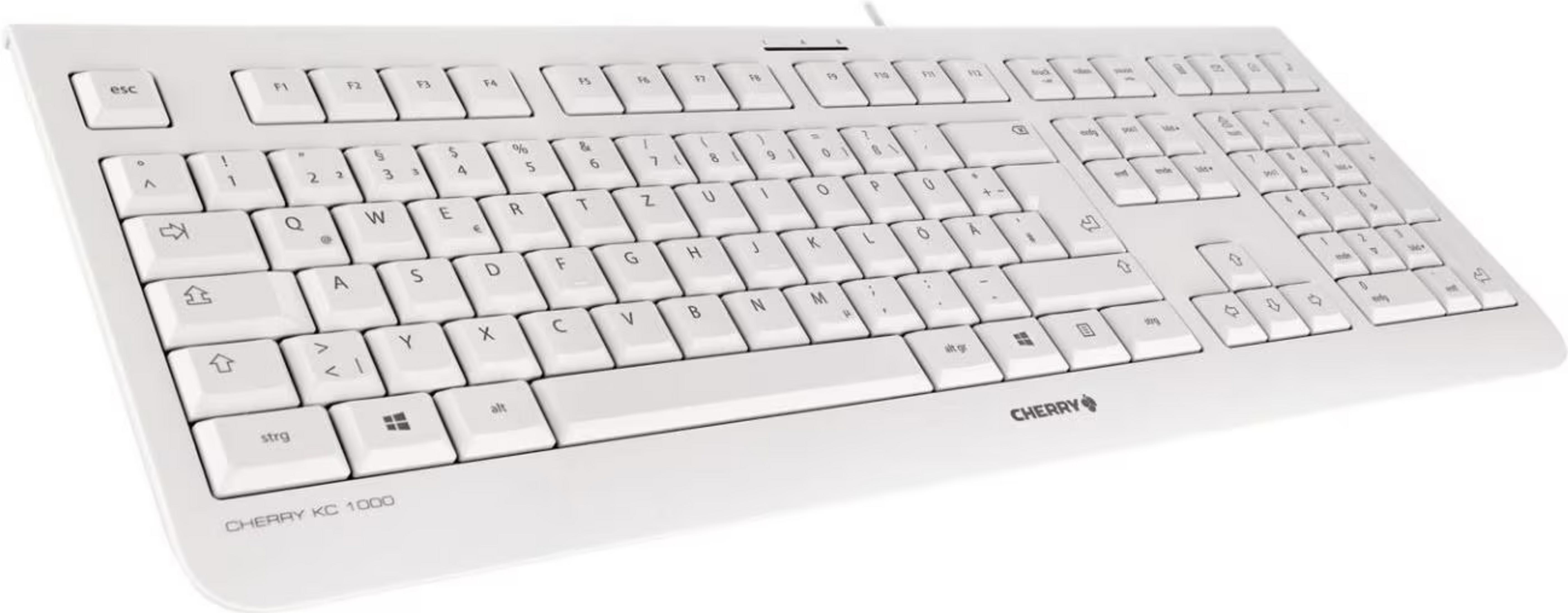 Un teclado Cherry KC 1000 blanco con etiquetas de teclas alemanas sobre fondo blanco.