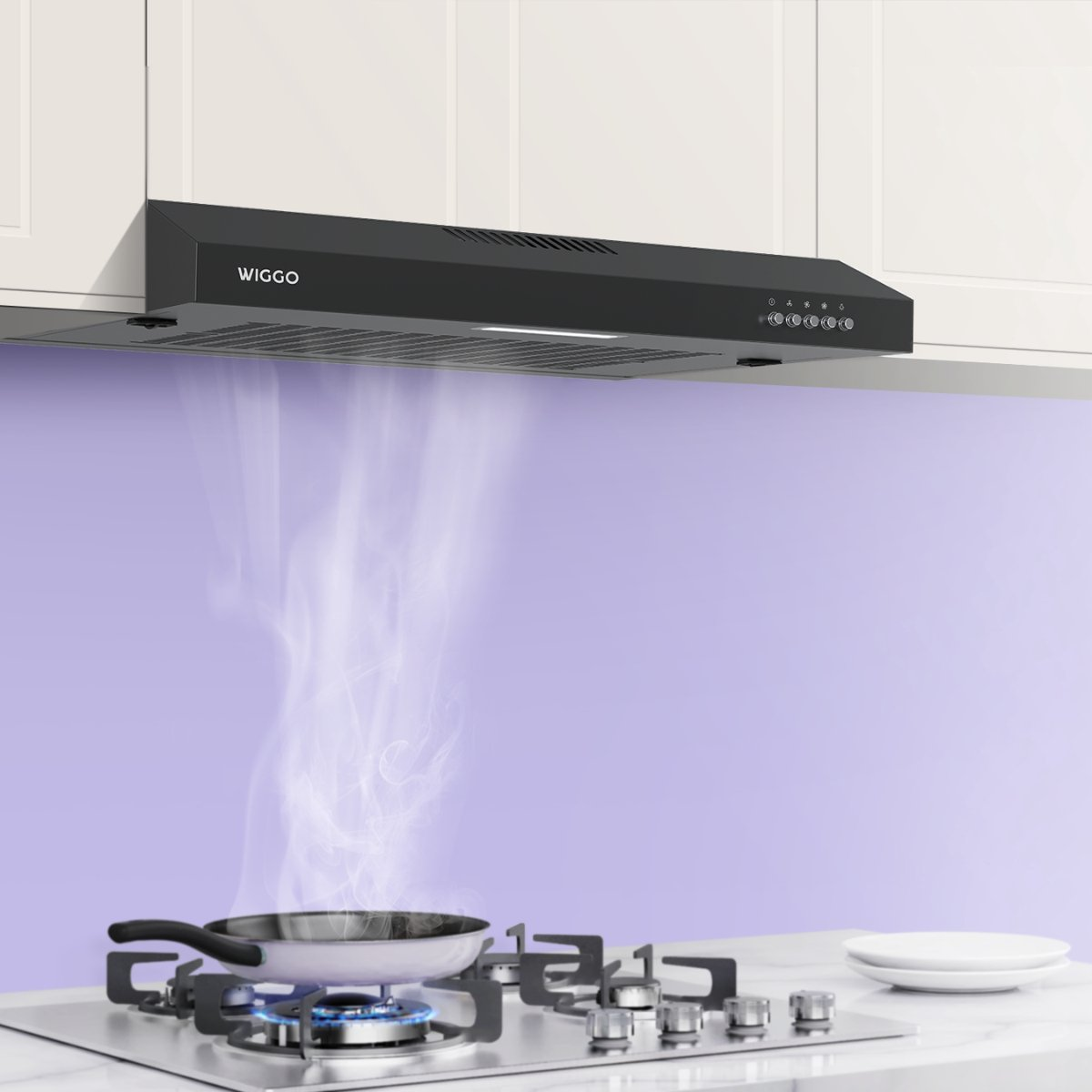 Range hood above gas stove with frying pan, steam rising.