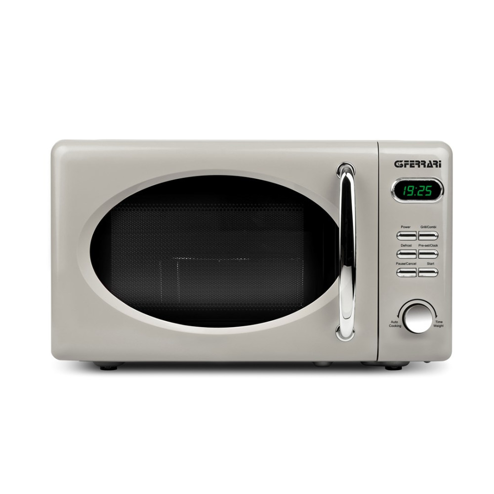 Un forno a microonde retrò color crema con manico e pannello argentati.