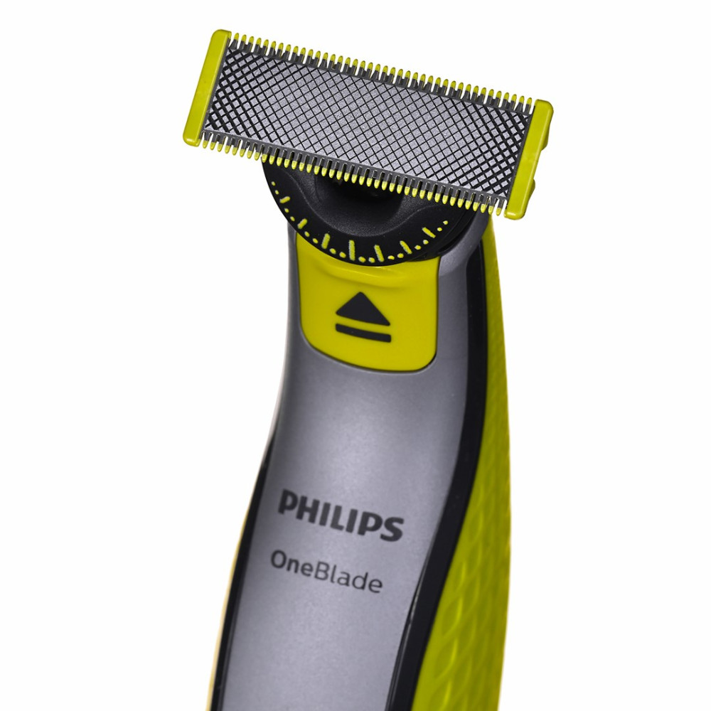 Zbliżenie żółtej i szarej maszynki Philips OneBlade ze srebrną głowicą tnącą.