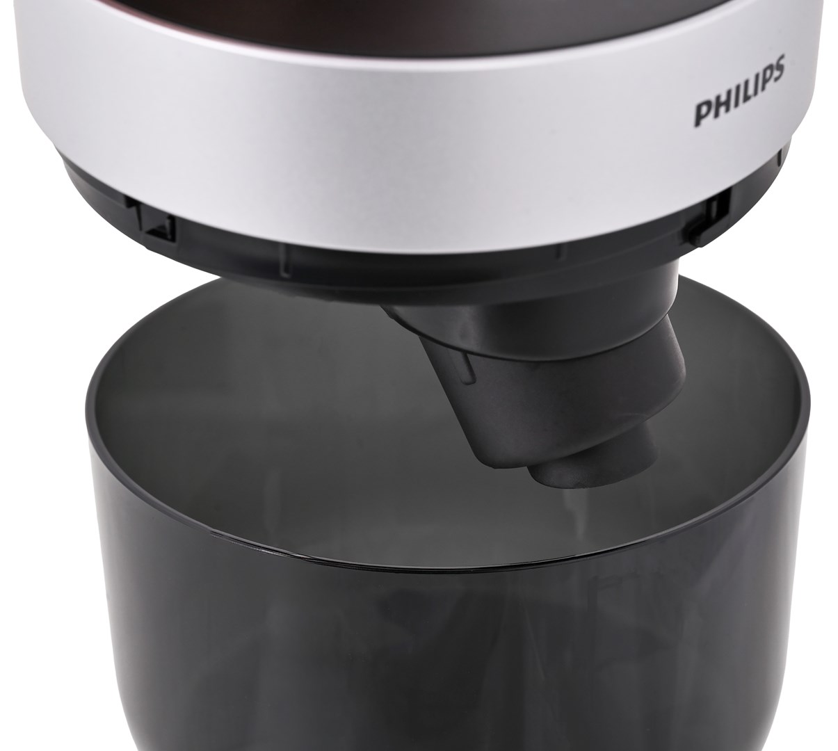 Zbliżenie czarnego pojemnika z srebrnym urządzeniem Philips nad nim.