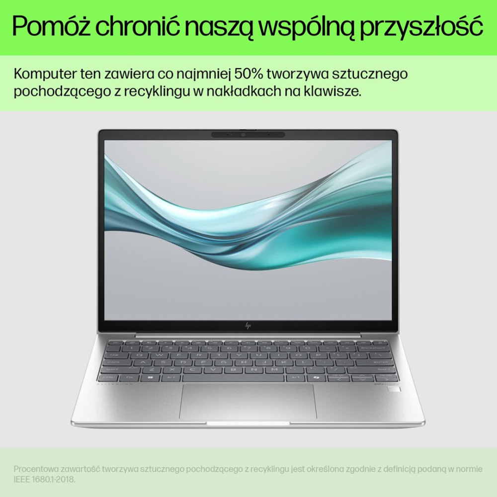 Srebrny laptop z abstrakcyjnym niebieskim wzorem na ekranie.