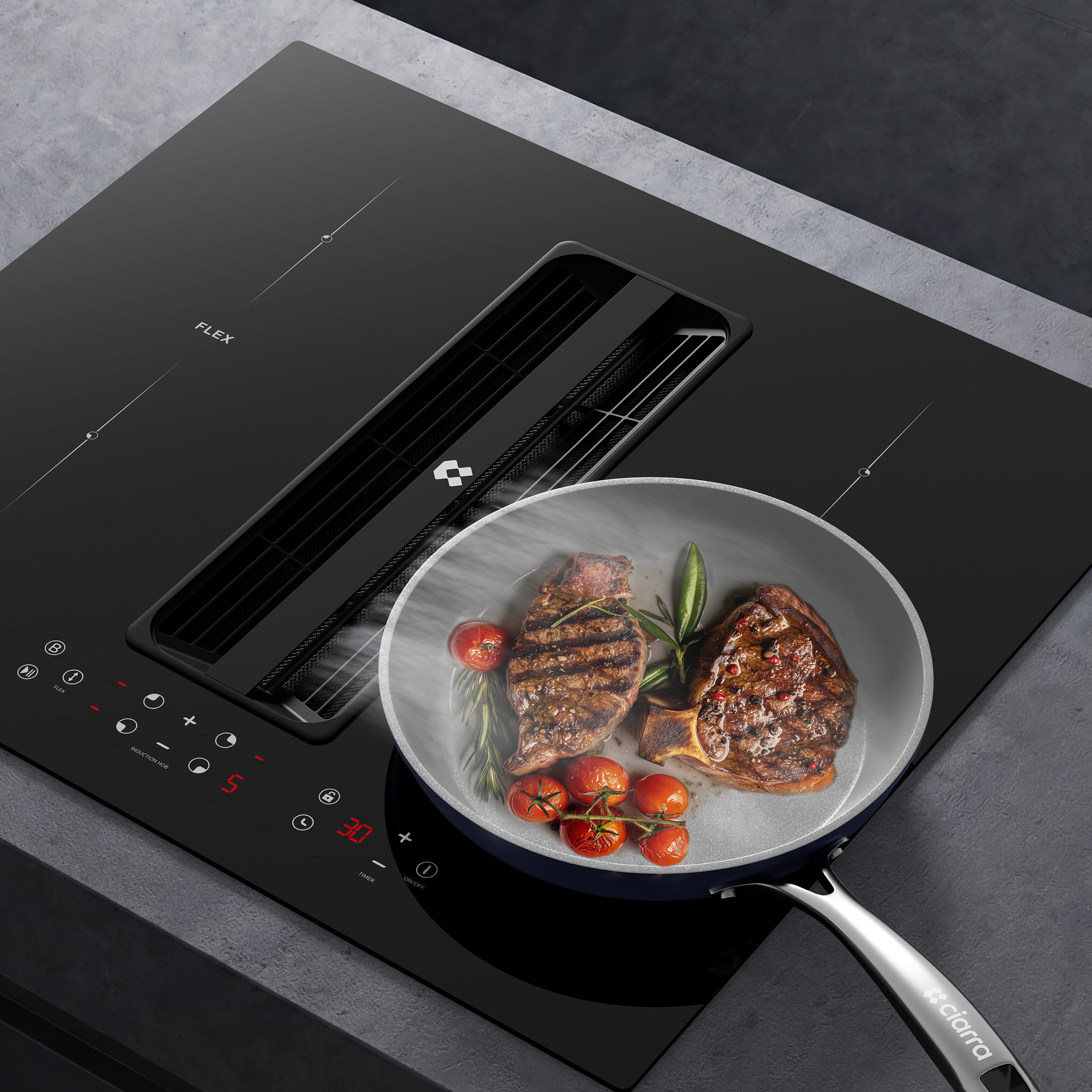 Overhead view of a black induction hob with an integrated extractor, searing two steaks and cherry tomatoes in a pan.