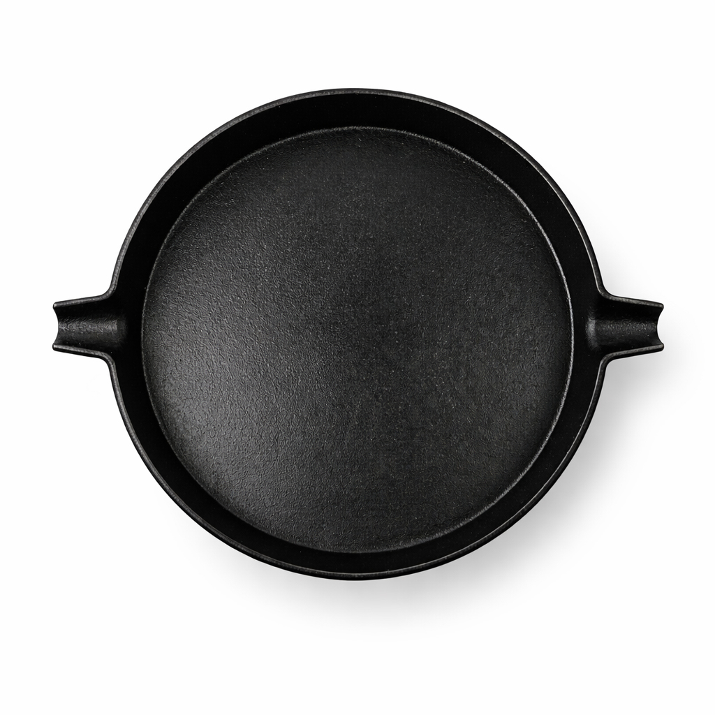 A black cast iron griddle with handles on a white background.