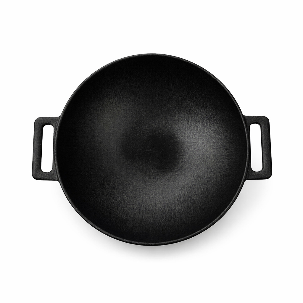 A black cast iron wok pan with two handles, viewed from above.