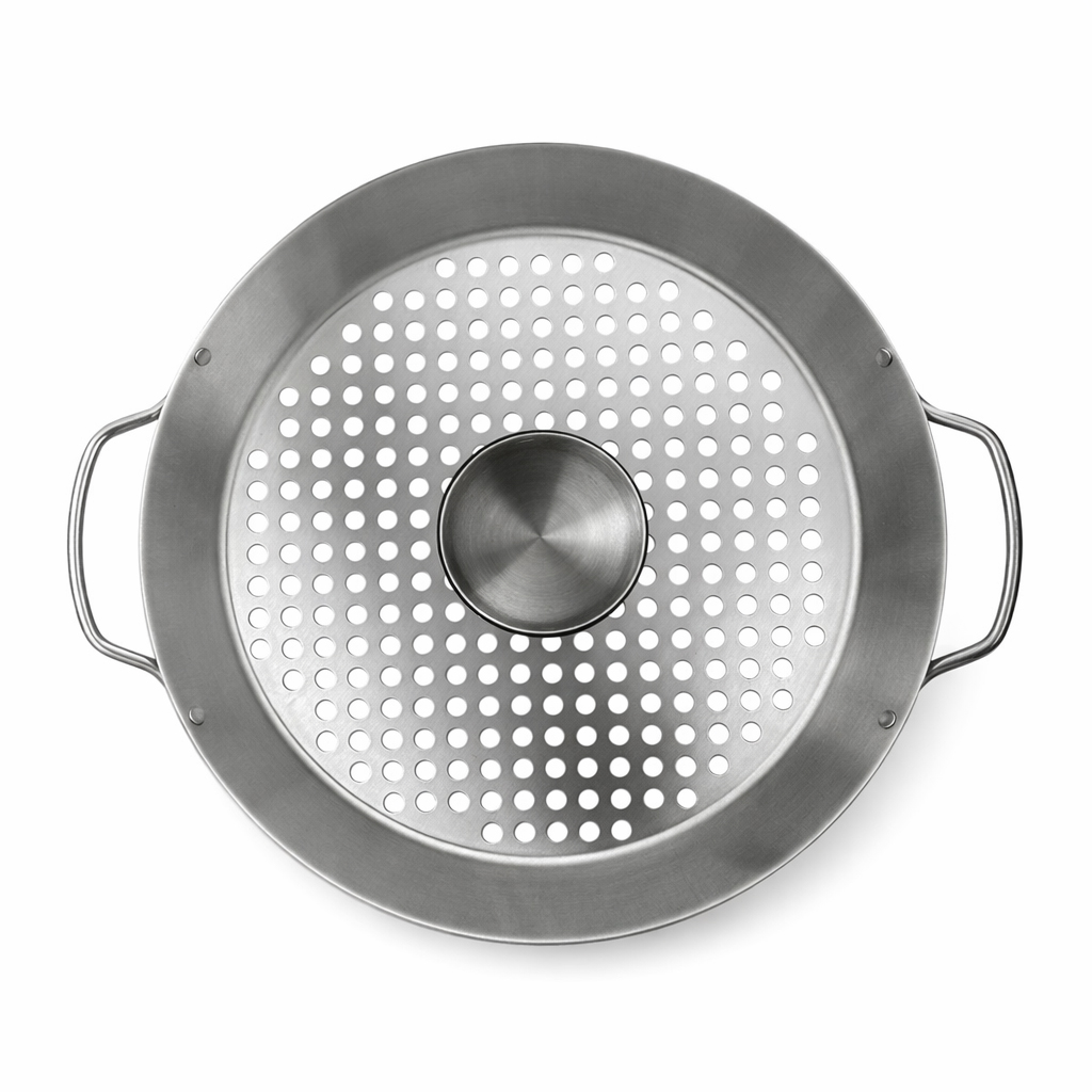 A round metal grill pan with perforations and handles.