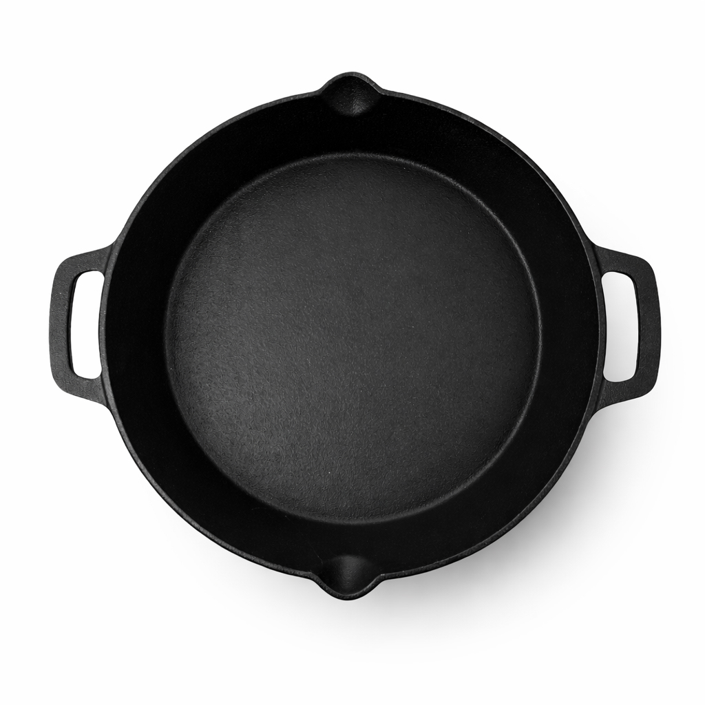 A round, black cast iron pan with two small handles on opposite sides, shot from directly above on a white background.