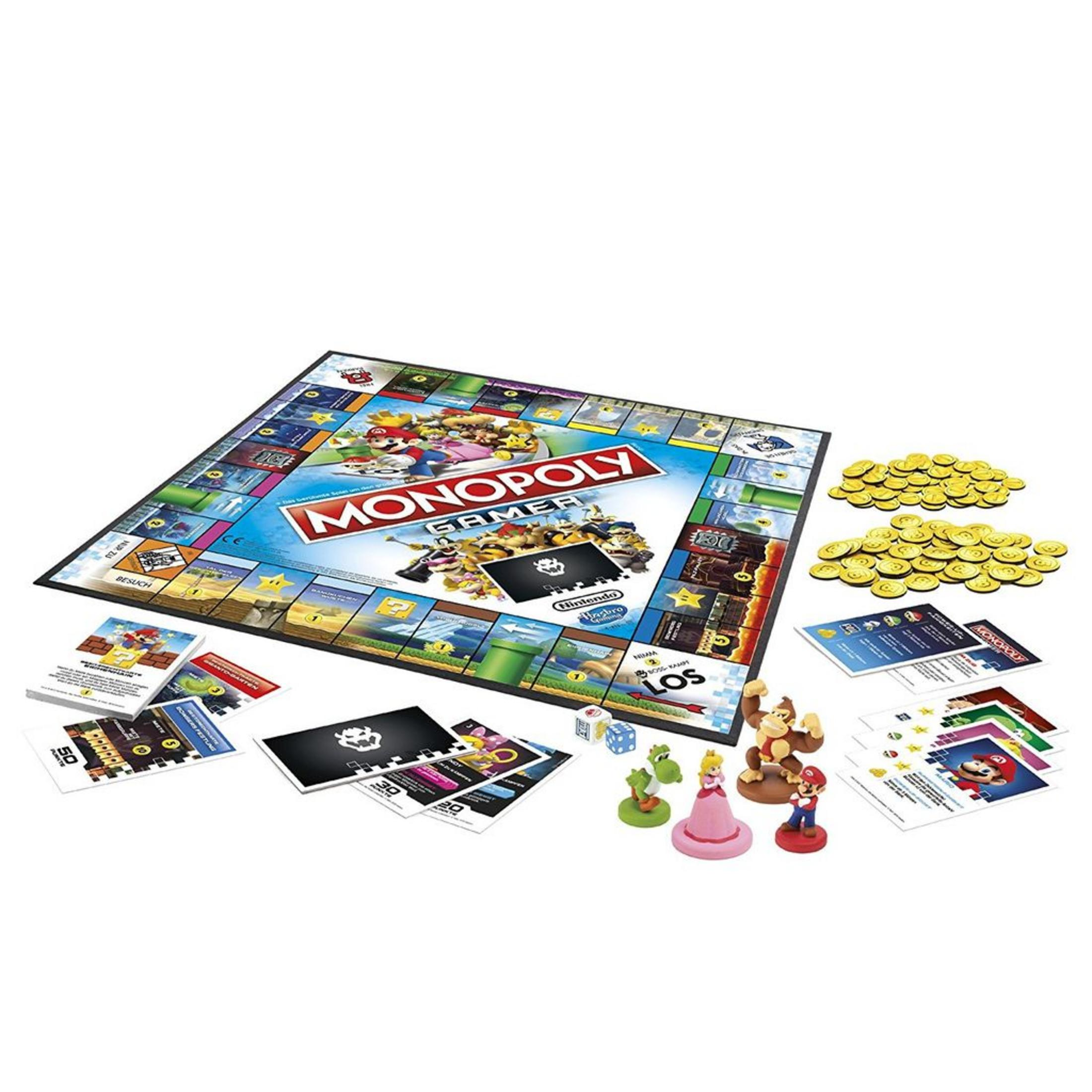 Monopoly Gamer Brettspiel mit Mario-Charakteren, Karten, Würfeln und Goldmünzen auf einer weißen Oberfläche ausgebreitet.