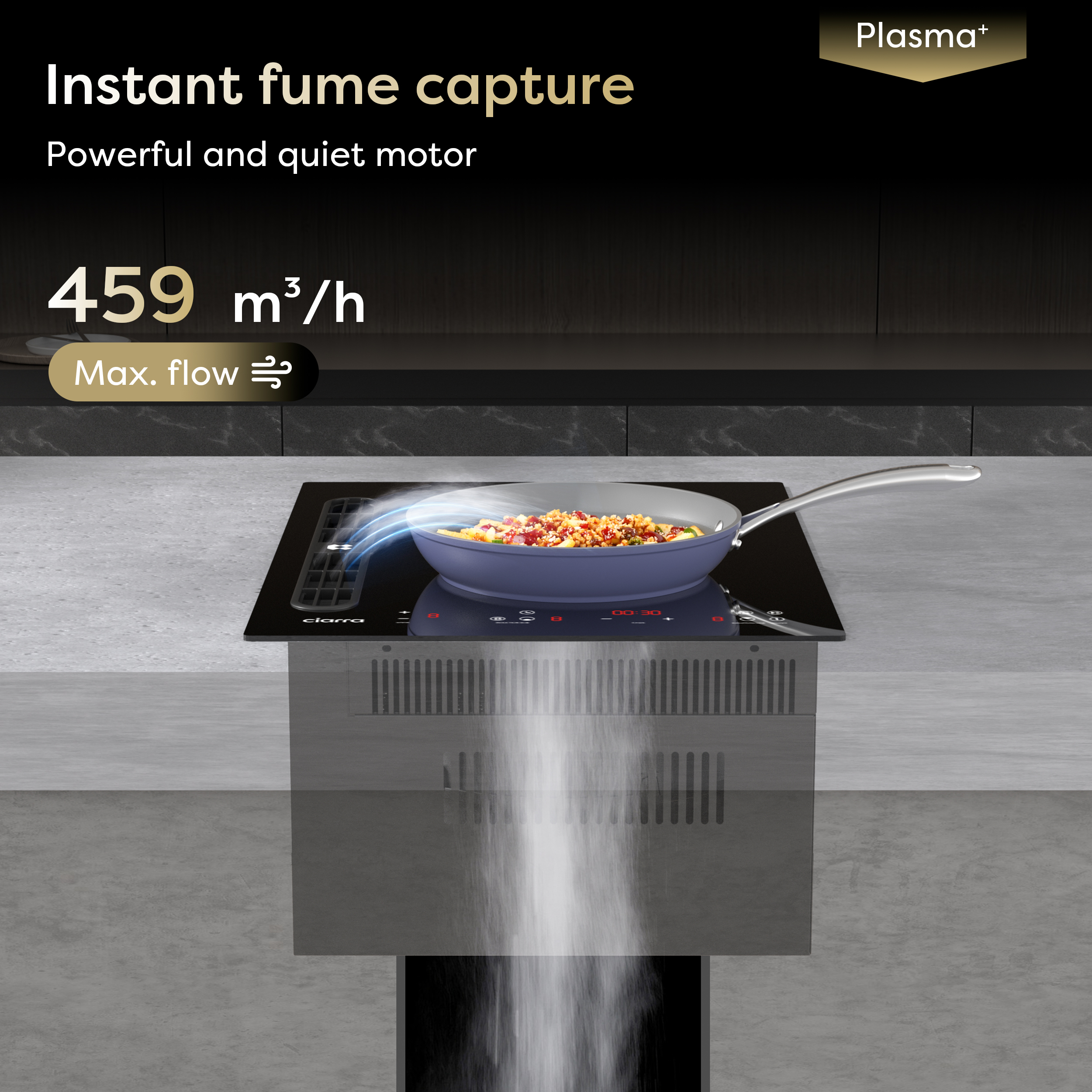 A frying pan with food on a black induction hob, with steam being pulled downwards into a vent.