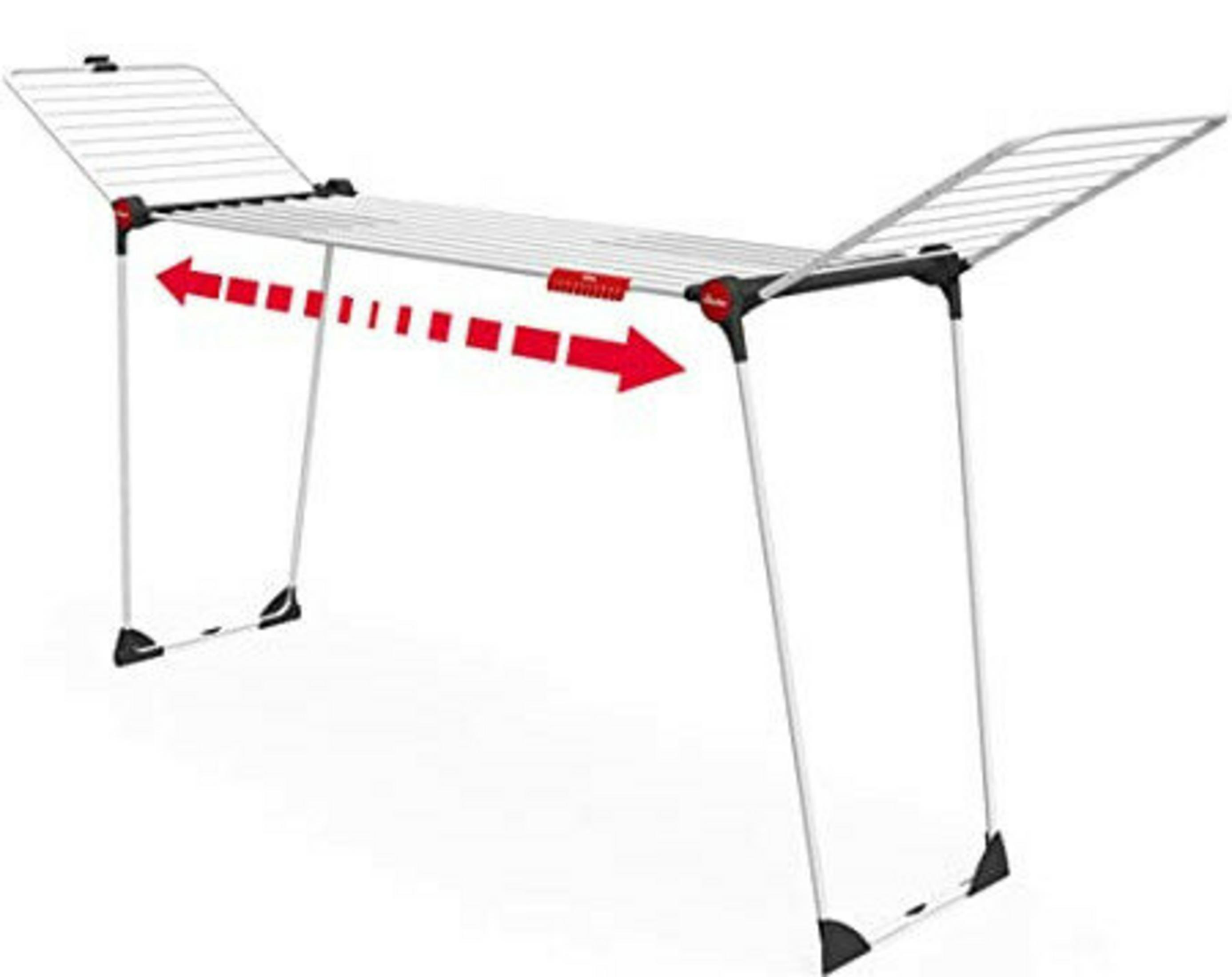 Rozkładana suszarka do ubrań z czerwonymi strzałkami wskazującymi rozszerzenie.