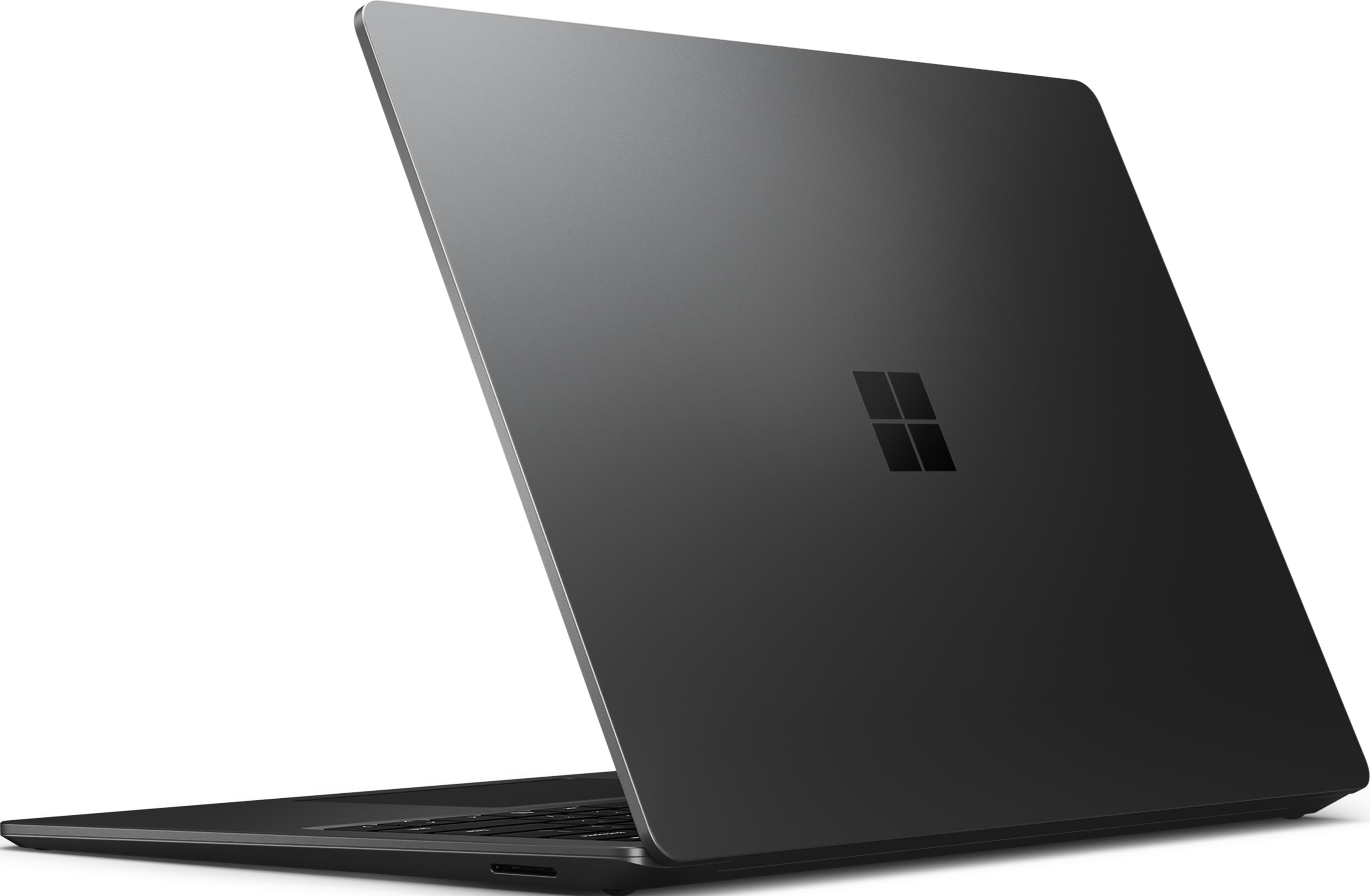 Un portátil oscuro con el logo de Windows en su tapa cerrada.