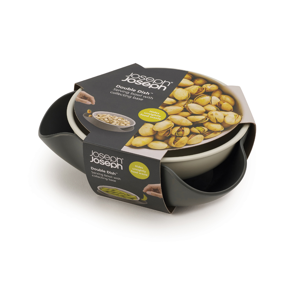 Ciotola Joseph Joseph Double Dish con base raccoglipistacchi, piena di pistacchi.