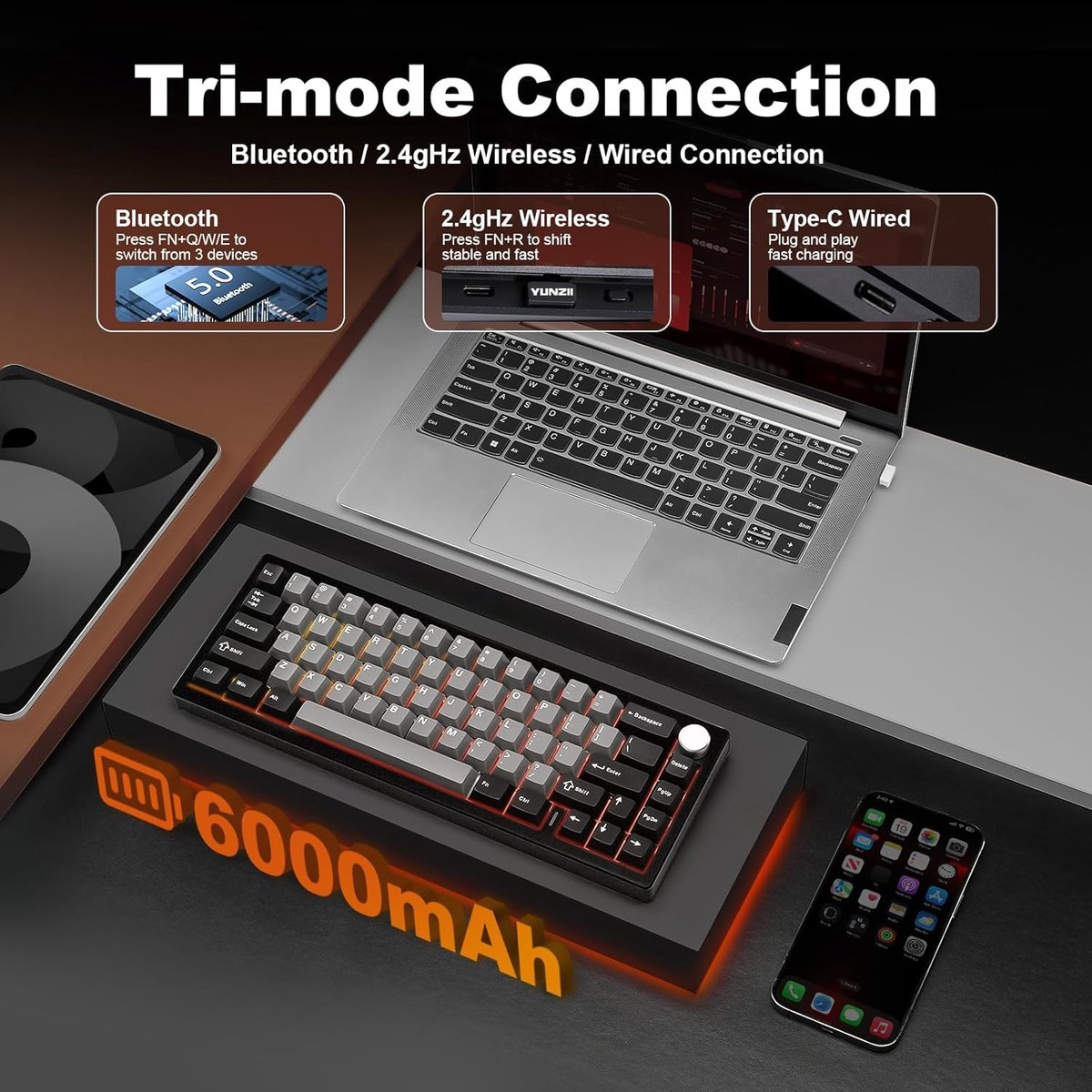 Toetsenbord met laptop, telefoon en batterij-icoon. Tri-mode verbinding.