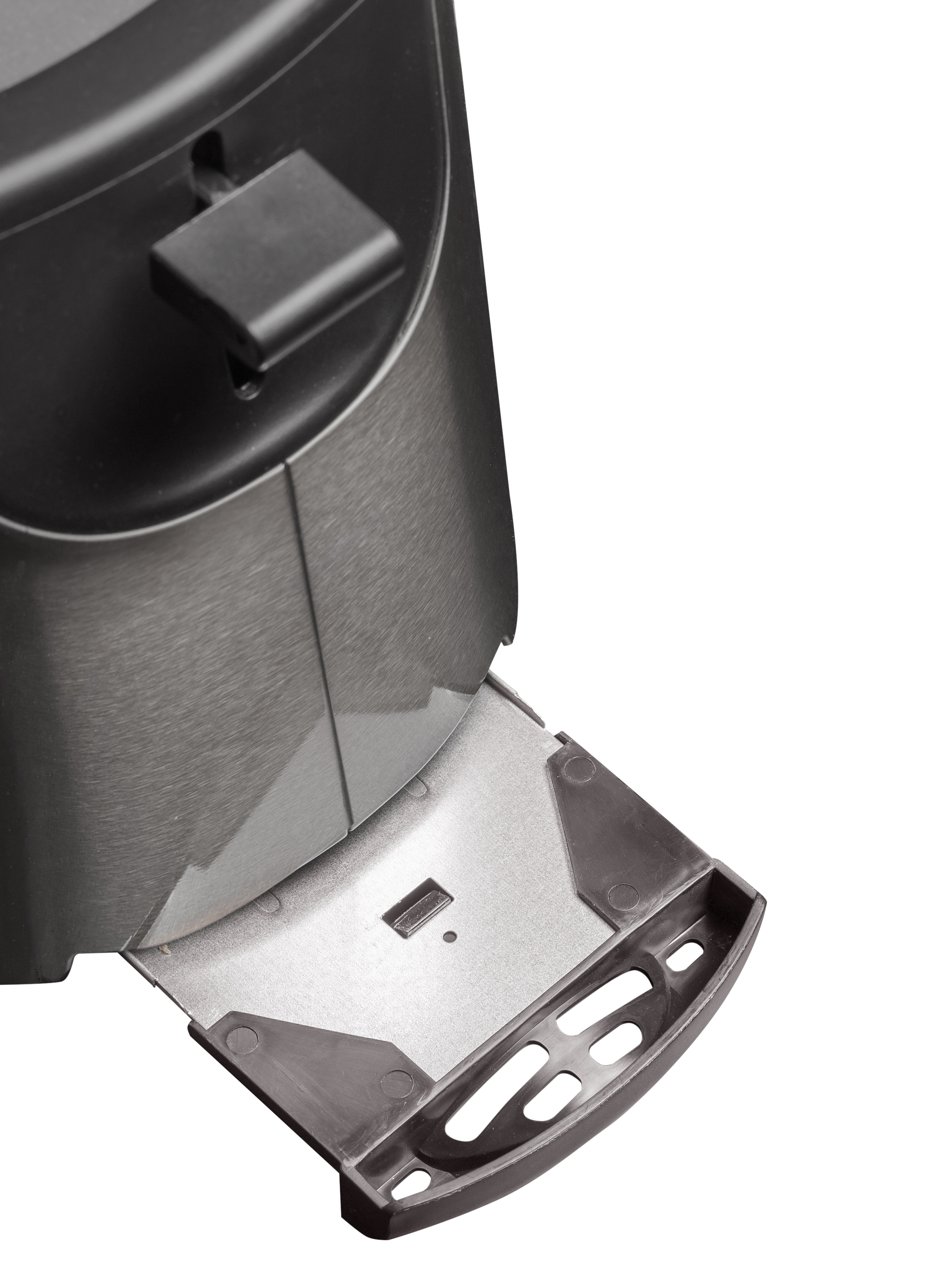 Primo piano di un pulsante nero su un elettrodomestico metallico con cassetto estraibile.