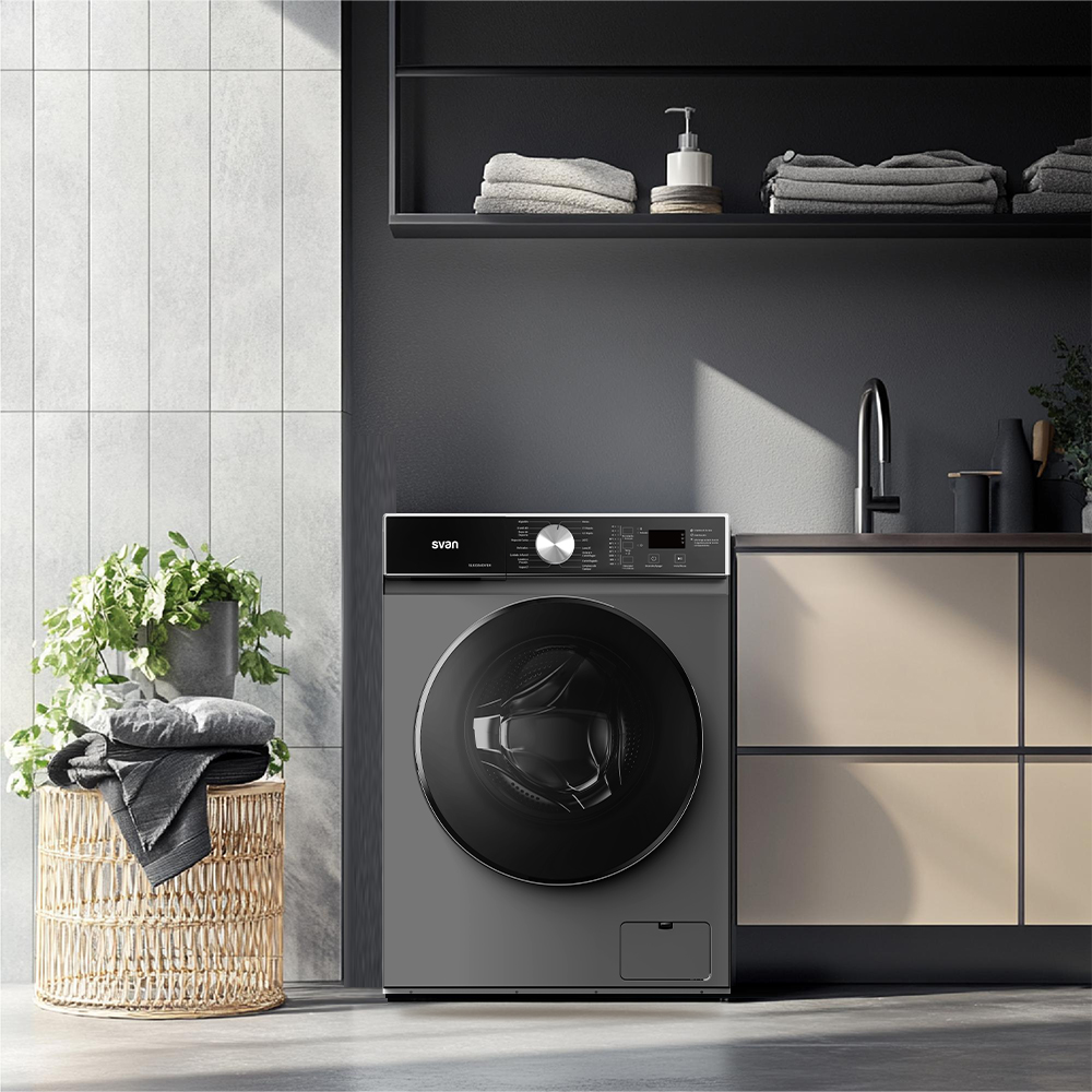 Lavadora gris junto a una cesta de mimbre con ropa y una planta.