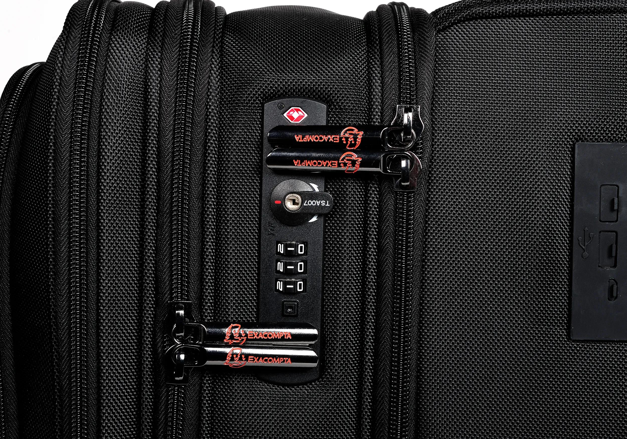 Maleta negra con cerradura TSA, cremalleras y puerto USB.