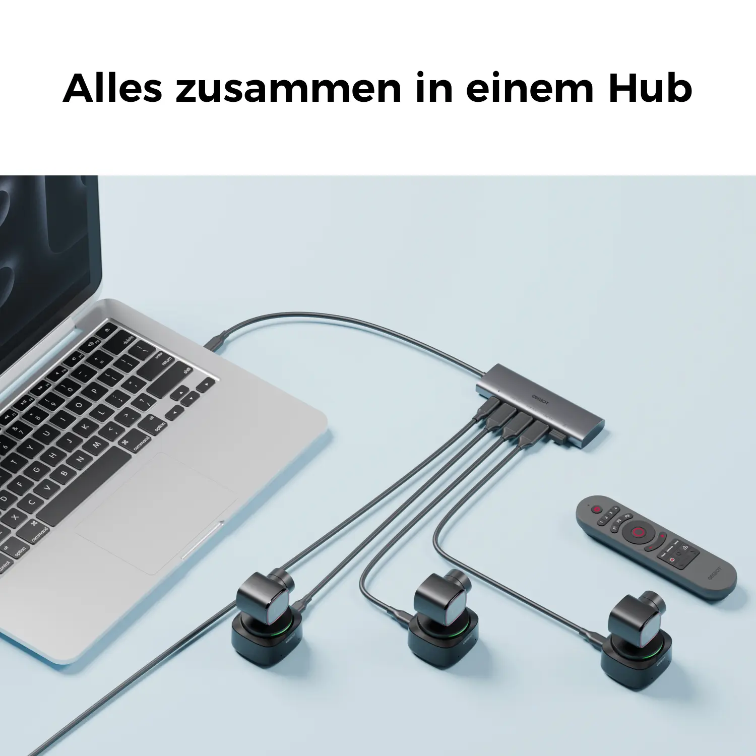 Un ordinateur portable, un hub, deux caméras et une télécommande sur fond bleu.