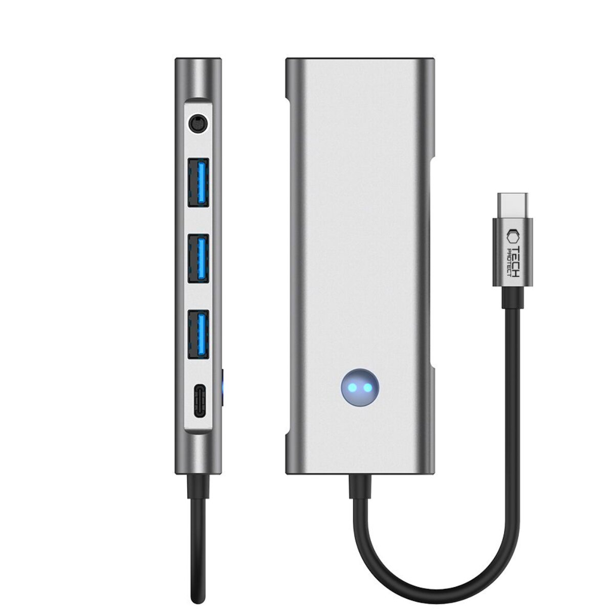 Hub USB-C argentato con tre porte USB e una porta di ricarica.