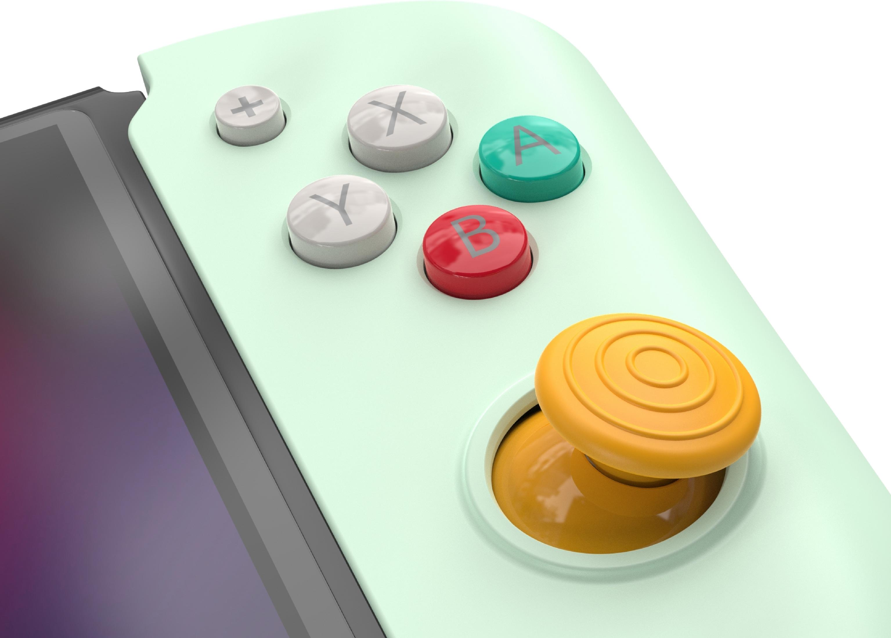 Ein hellgrüner Gamecontroller mit gelbem Joystick und bunten Tasten.