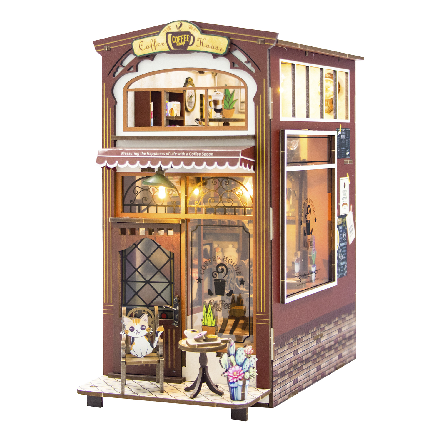Una mini casa del caffè con un gatto su una sedia e un tavolo fuori.