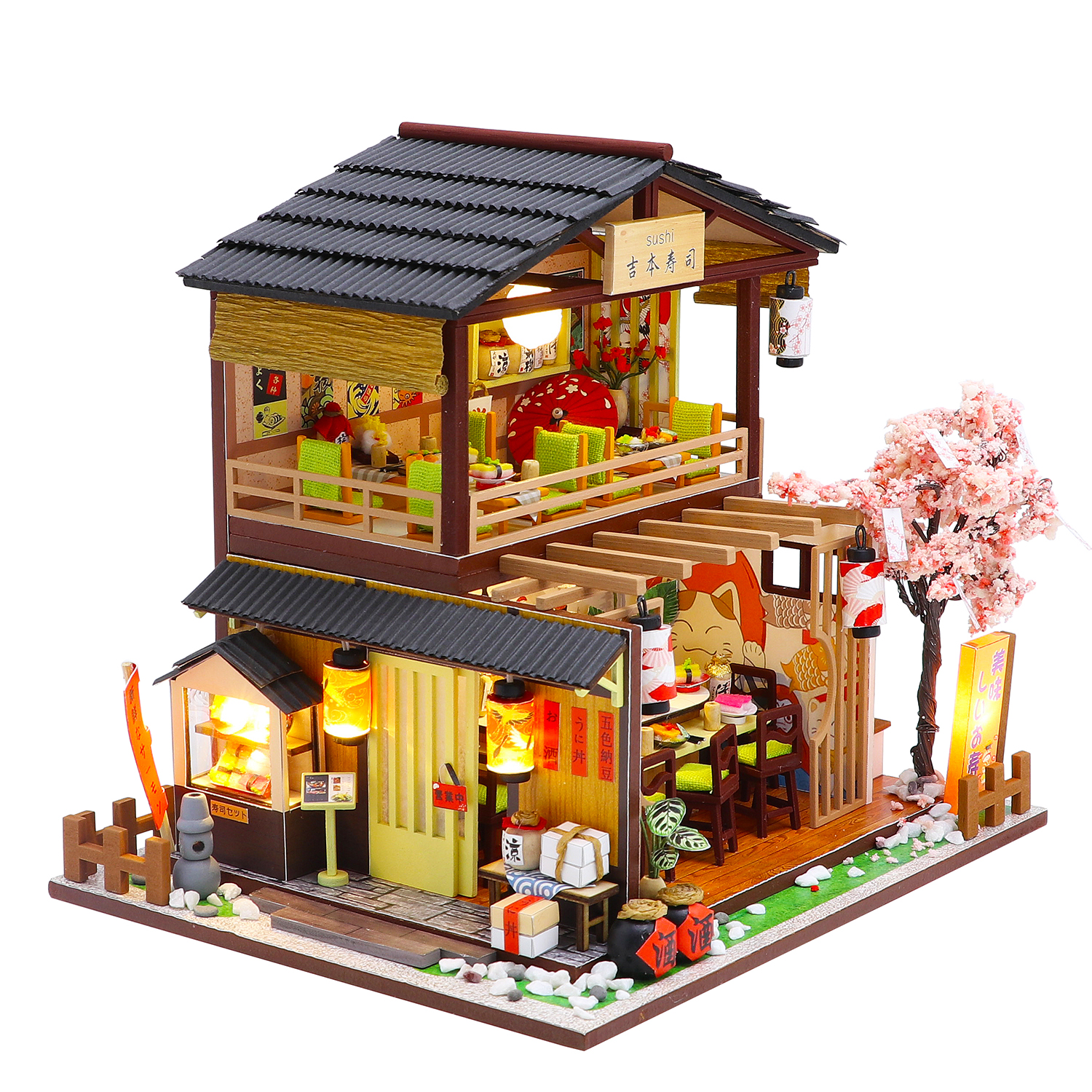 Ristorante di sushi in miniatura a due piani con ciliegio in fiore e lanterne accese.