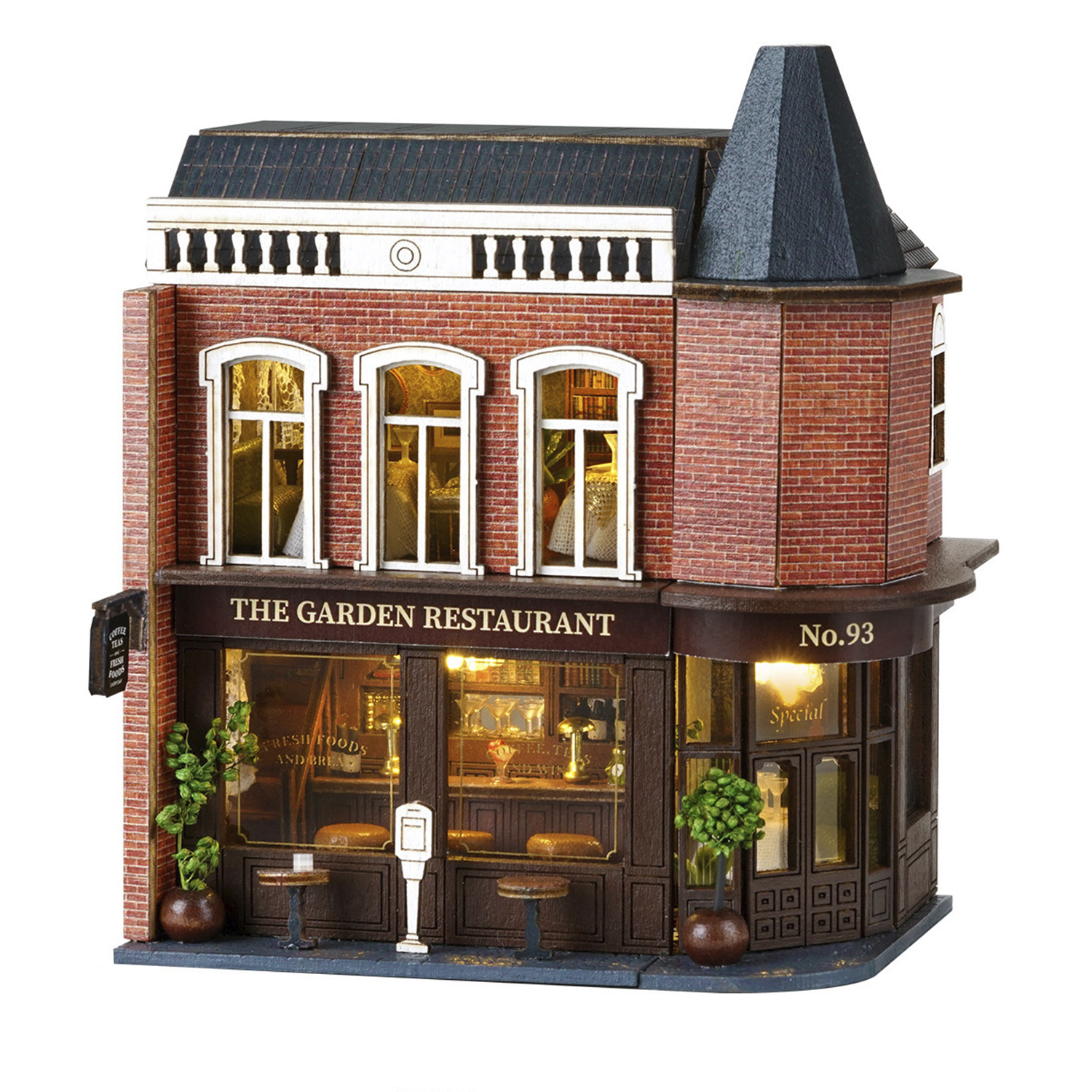 Modello in miniatura di "The Garden Restaurant" con facciata in mattoni, grandi finestre e posti a sedere.