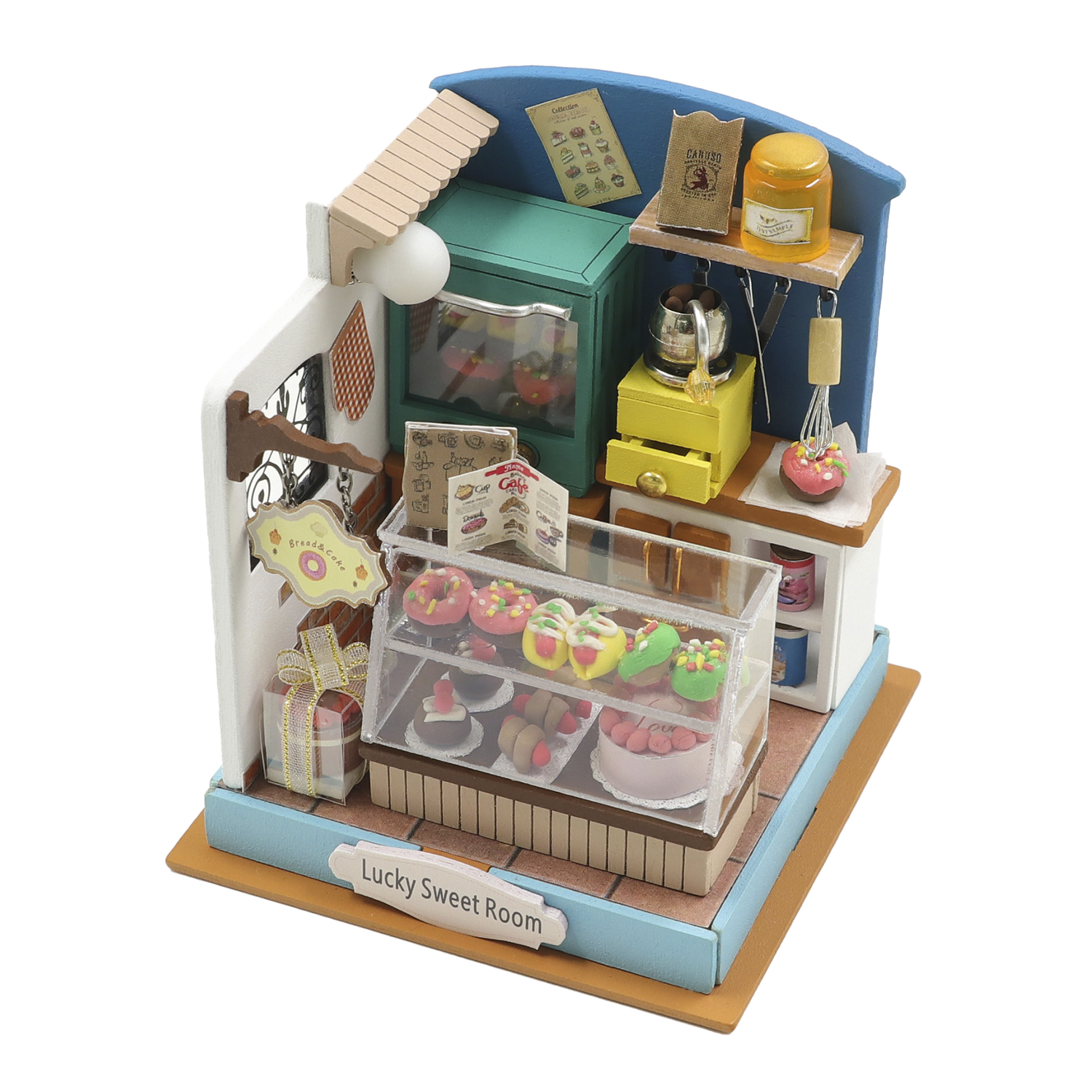 Espositore da panetteria in miniatura con ciambelle, torte e oggetti da cucina.