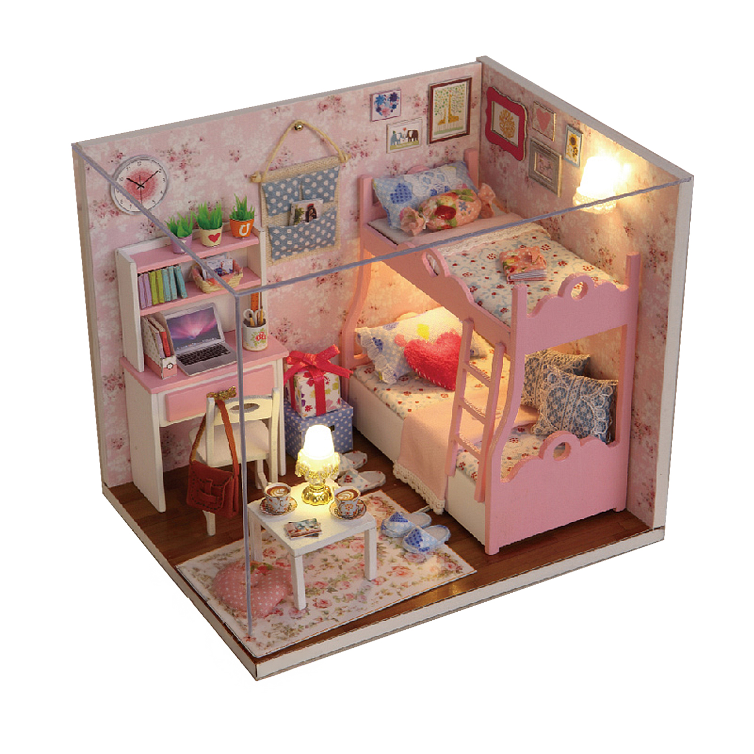 Una cameretta rosa in miniatura con letti a castello, scrivania e set da tè.