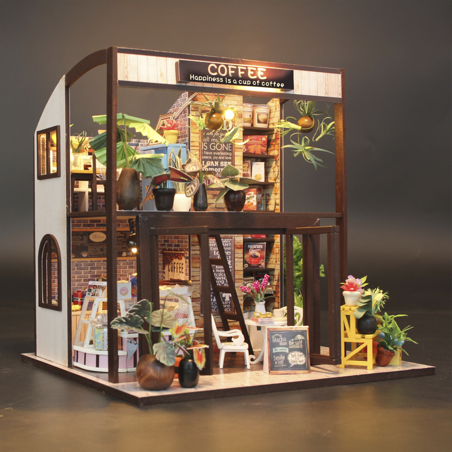 Caffetteria in miniatura con piante, posti a sedere e prodotti per caffè.