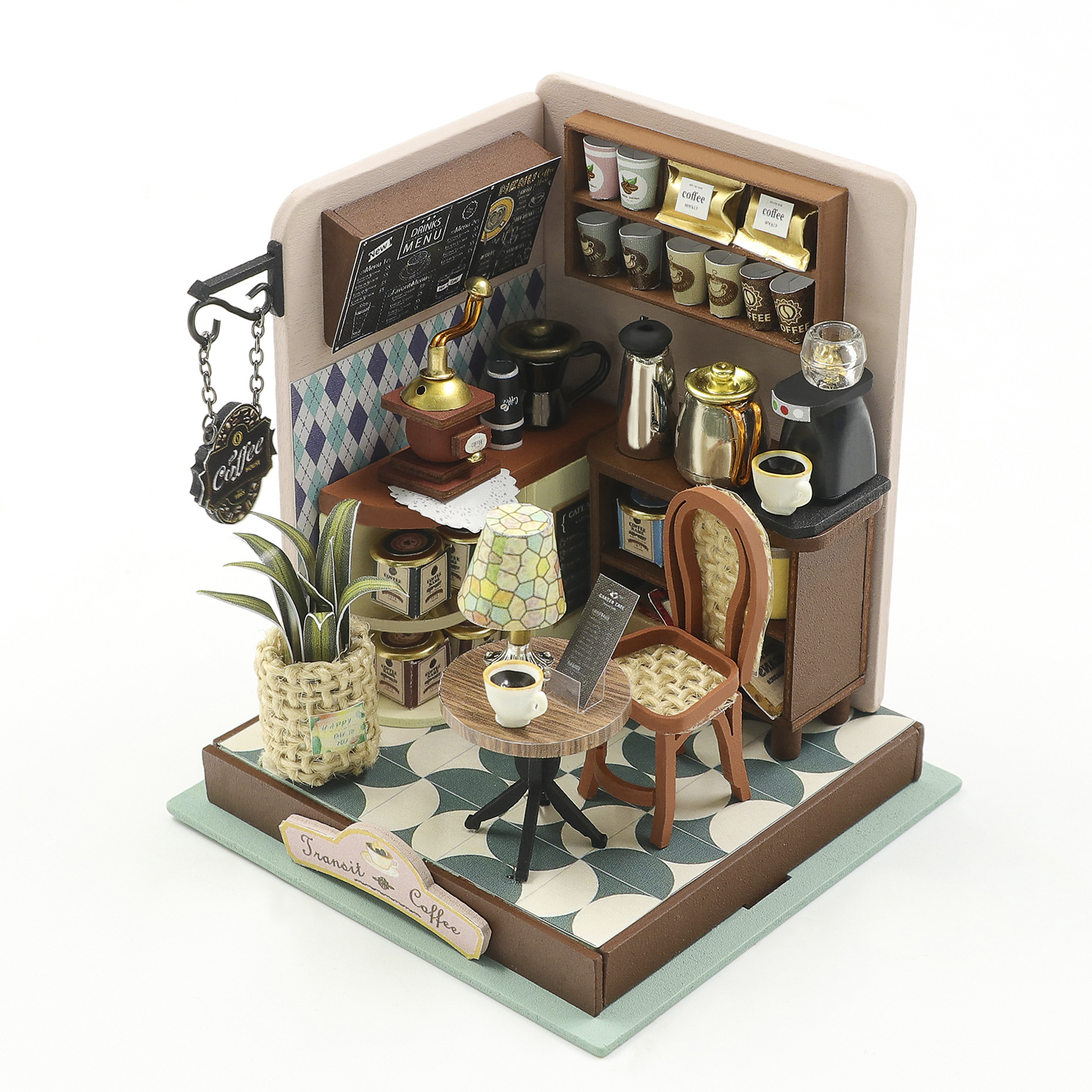 Miniatura di caffetteria con macchina da caffè, macinino, tavoli, sedie e decorazioni.