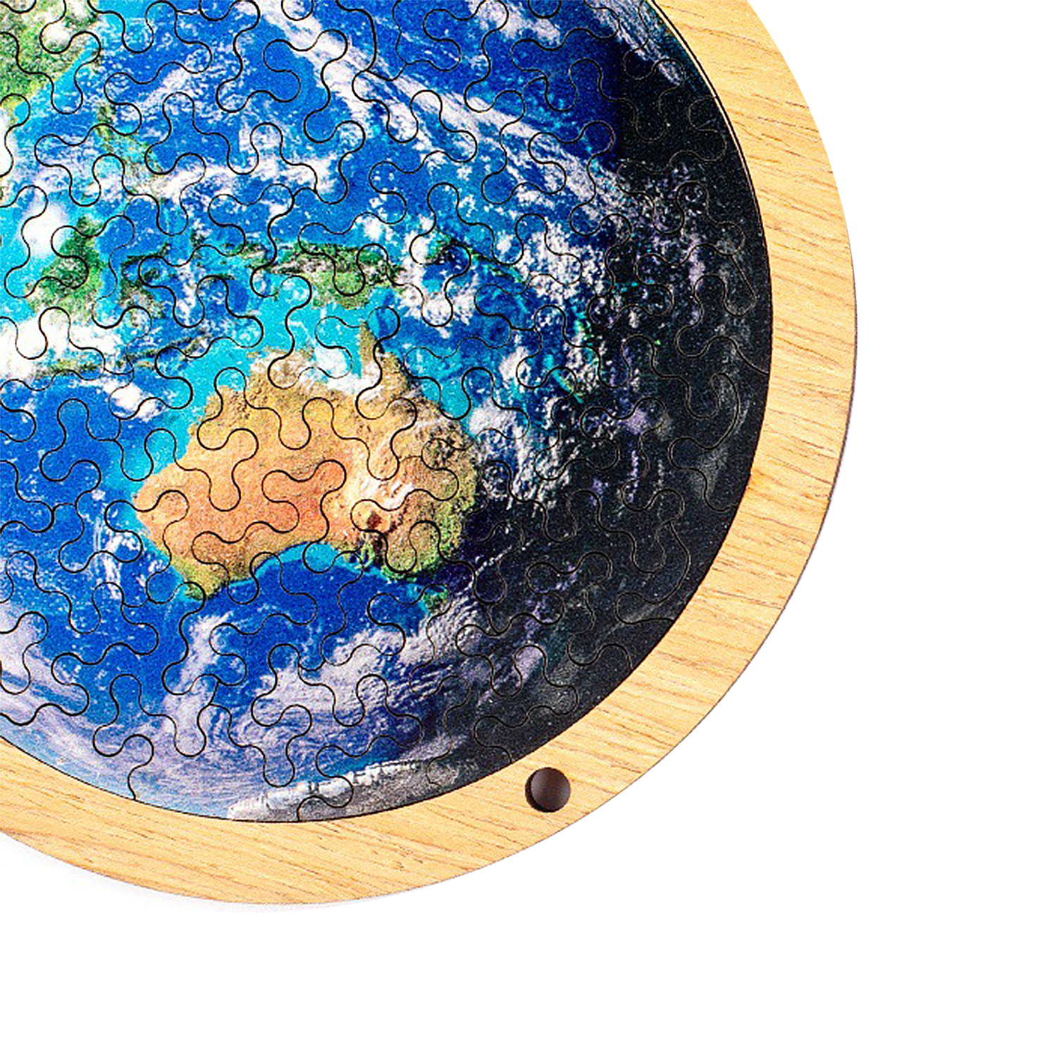 Puzzle in legno della Terra, l'Australia è visibile. Nuvole bianche sull'oceano blu.