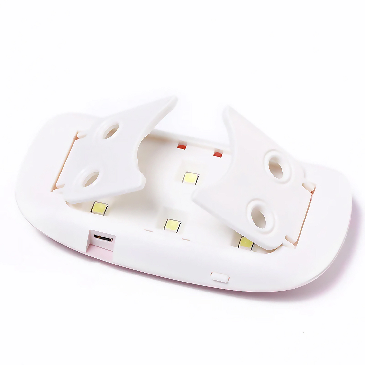 Un pequeño secador LED blanco para uñas con alas plegables y puerto USB.