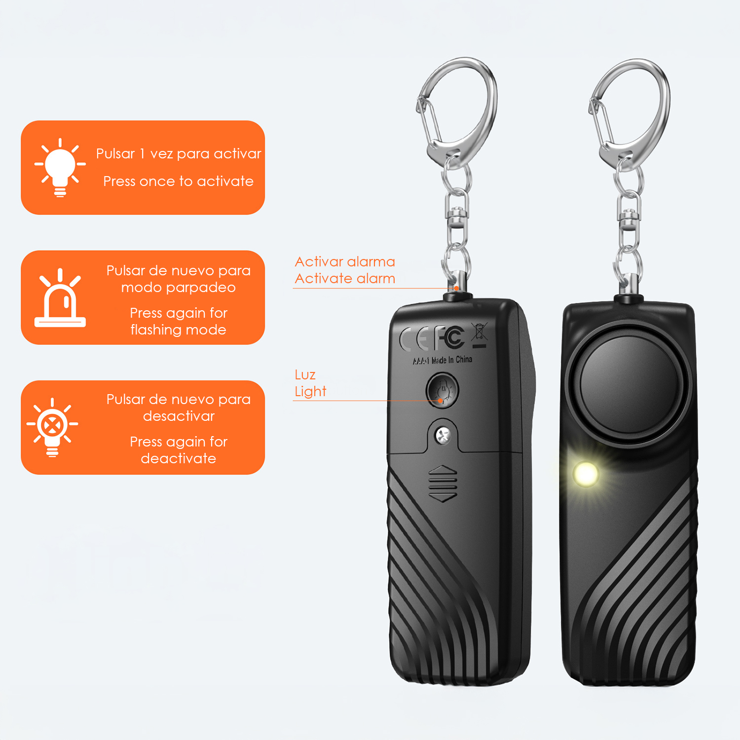 Dos dispositivos de alarma llavero negros con anillas. Uno está iluminado amarillo.