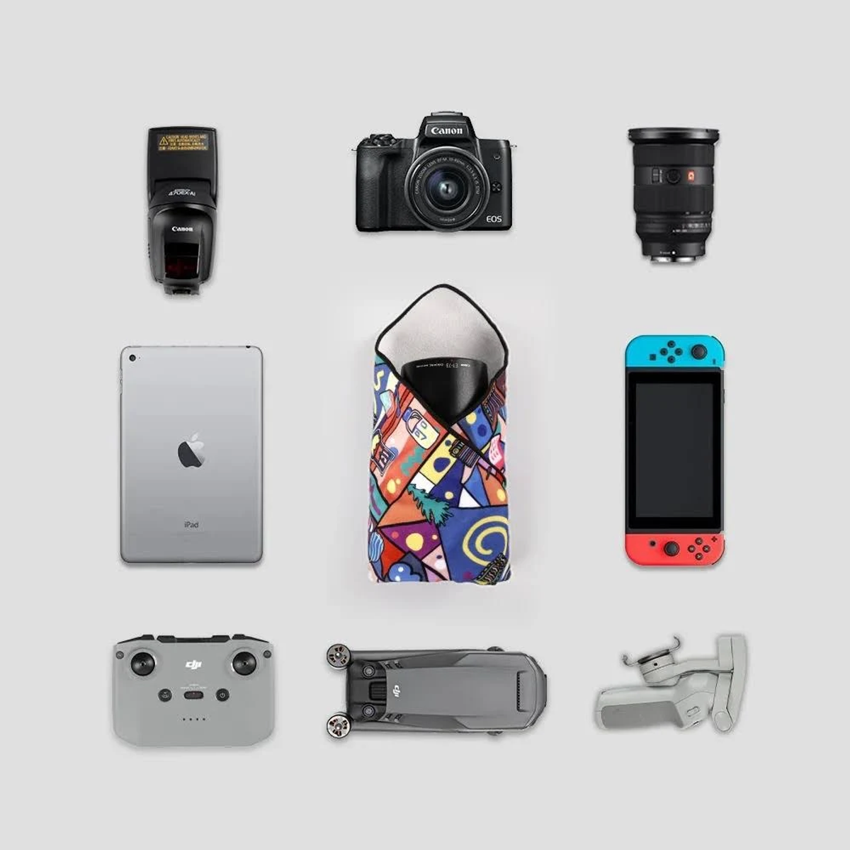 Eine Anordnung von Elektronik: Kamera, Objektiv, Blitz, iPad, Nintendo Switch, Drohne & Controller.